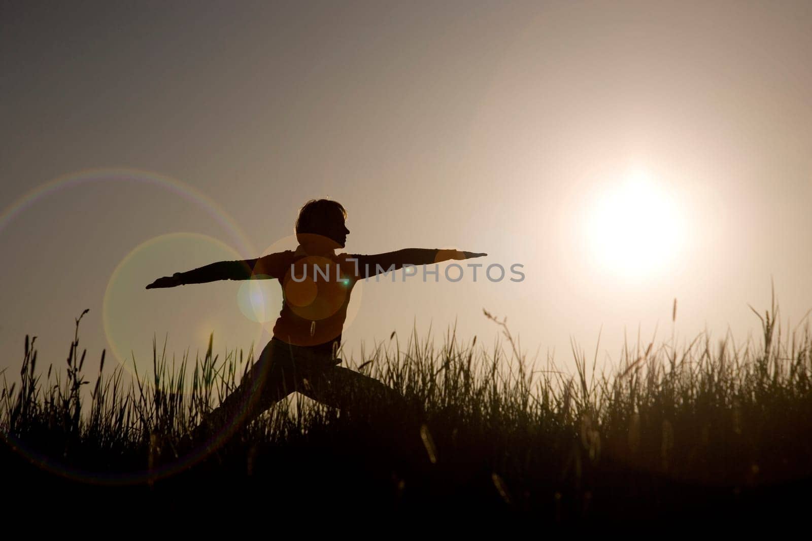 Woman doing yoga exercise - The Warrior I