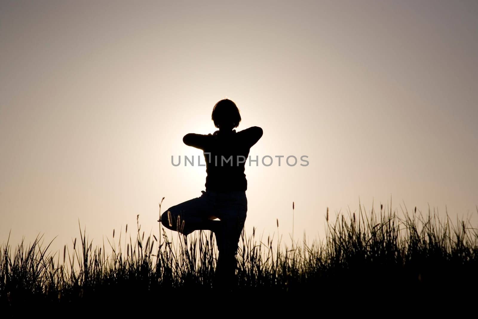 Woman doing yoga exercise - the tree