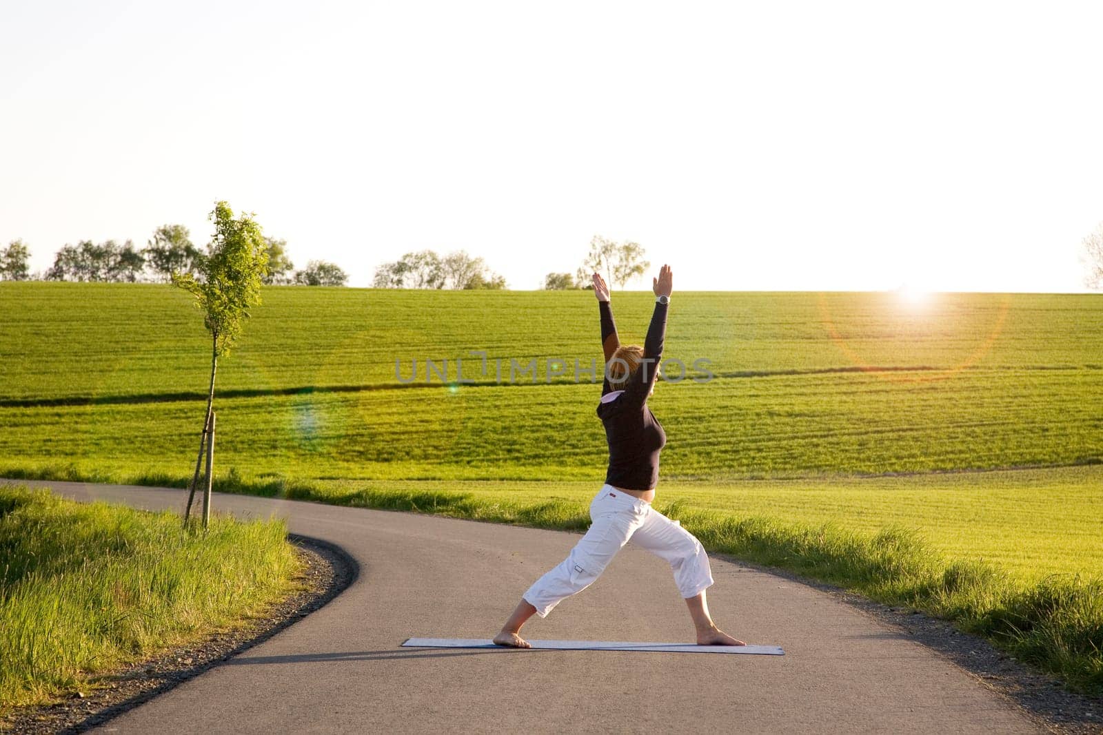 Woman Doing Yoga Exercise - The Warrior II