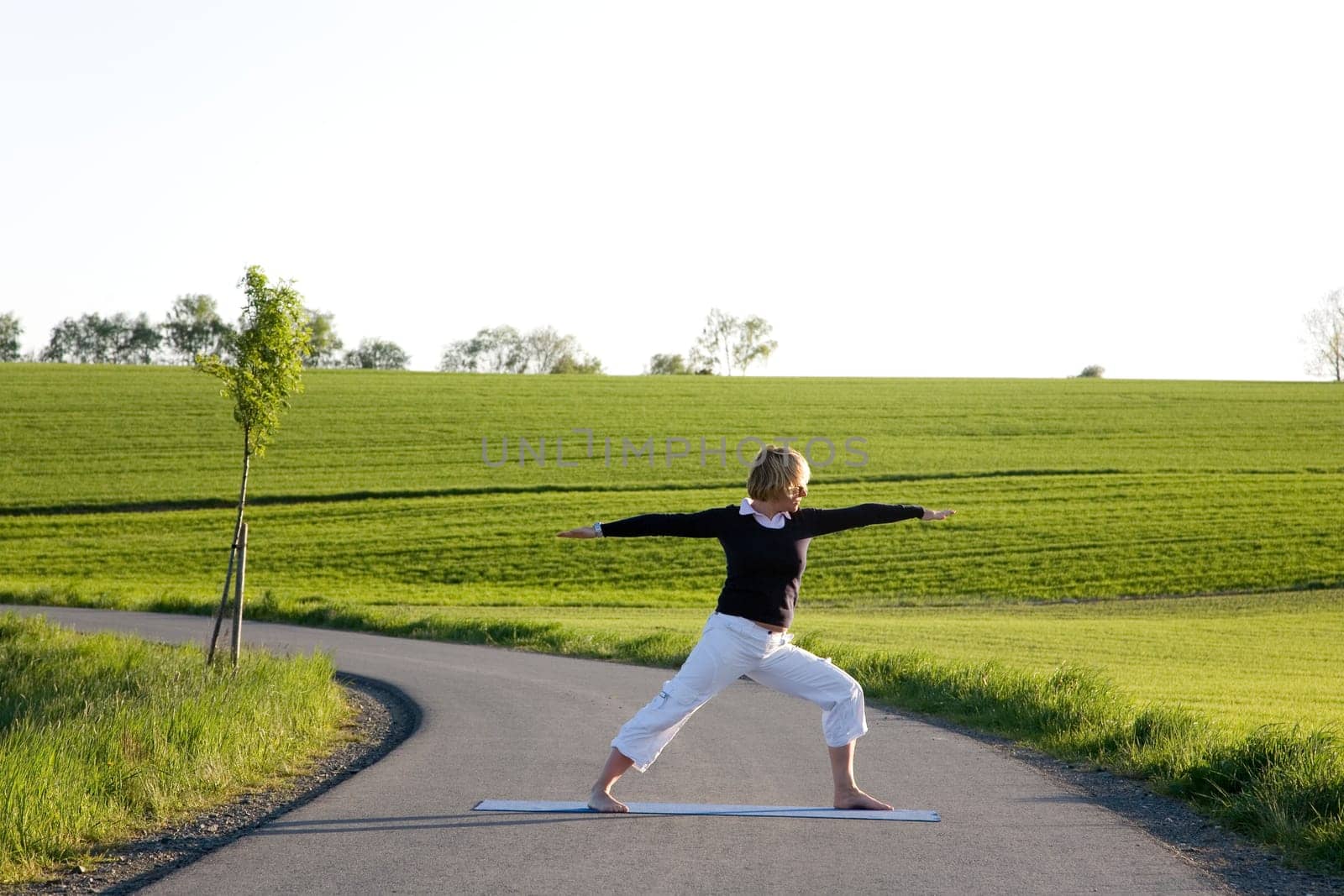 Woman doing yoga exercise - The Warrior I
