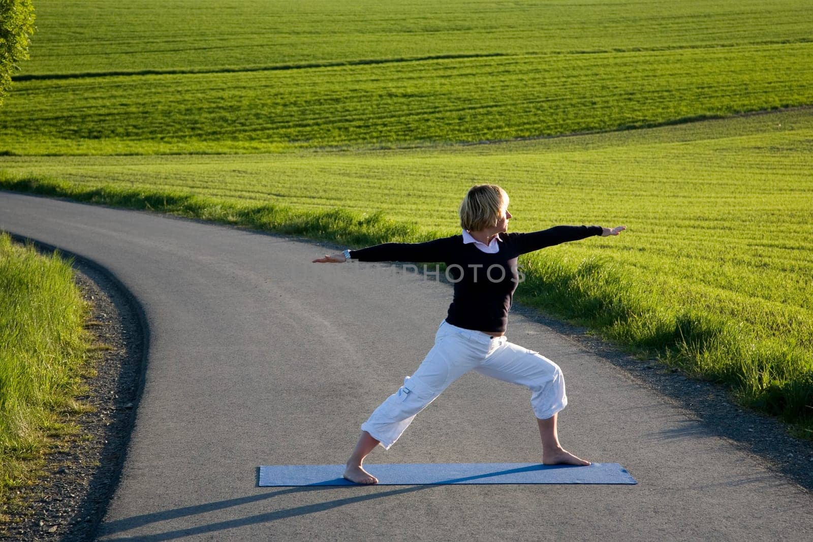 Woman doing yoga exercise - The Warrior I