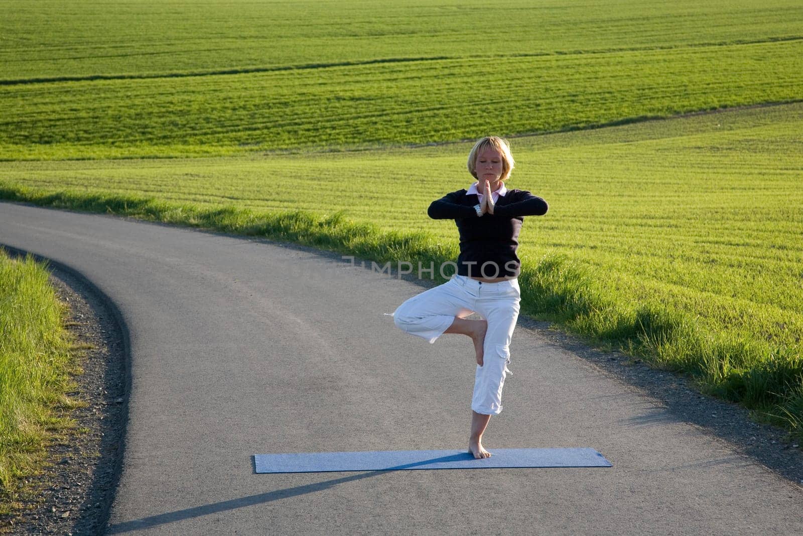 Woman doing yoga exercise - the tree