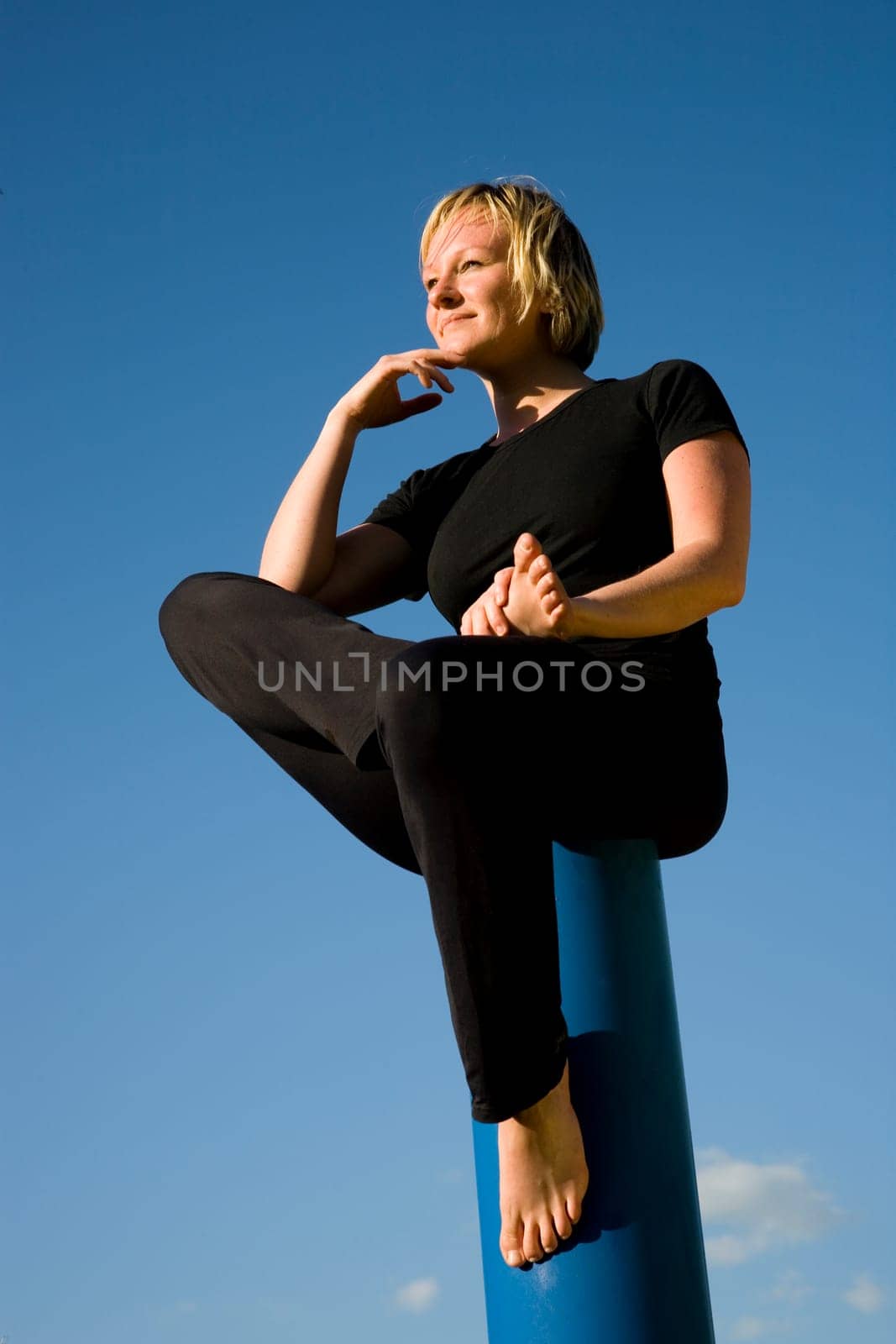 Woman sitting like a thinker