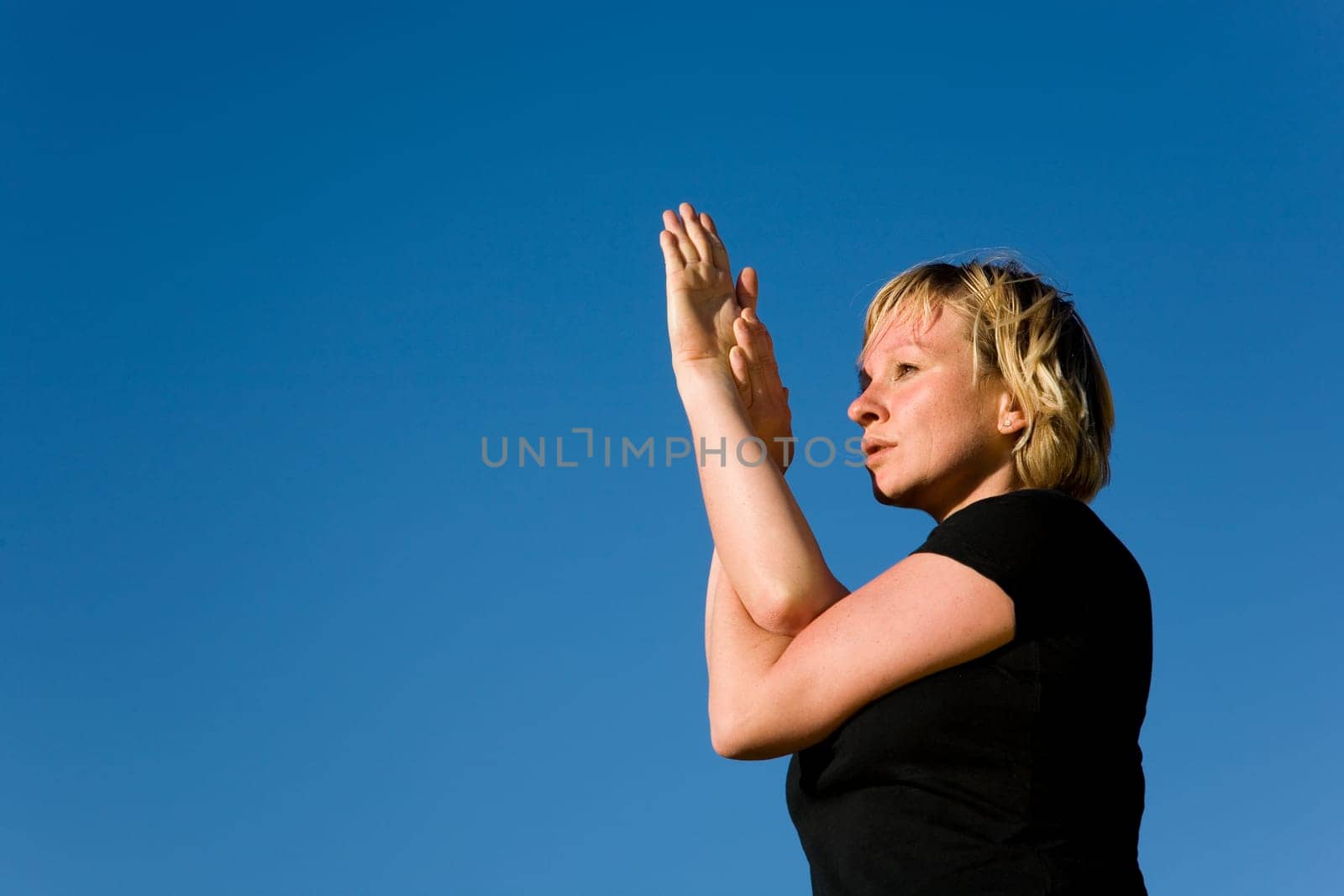 Woman doing yoga exercise - the eagle