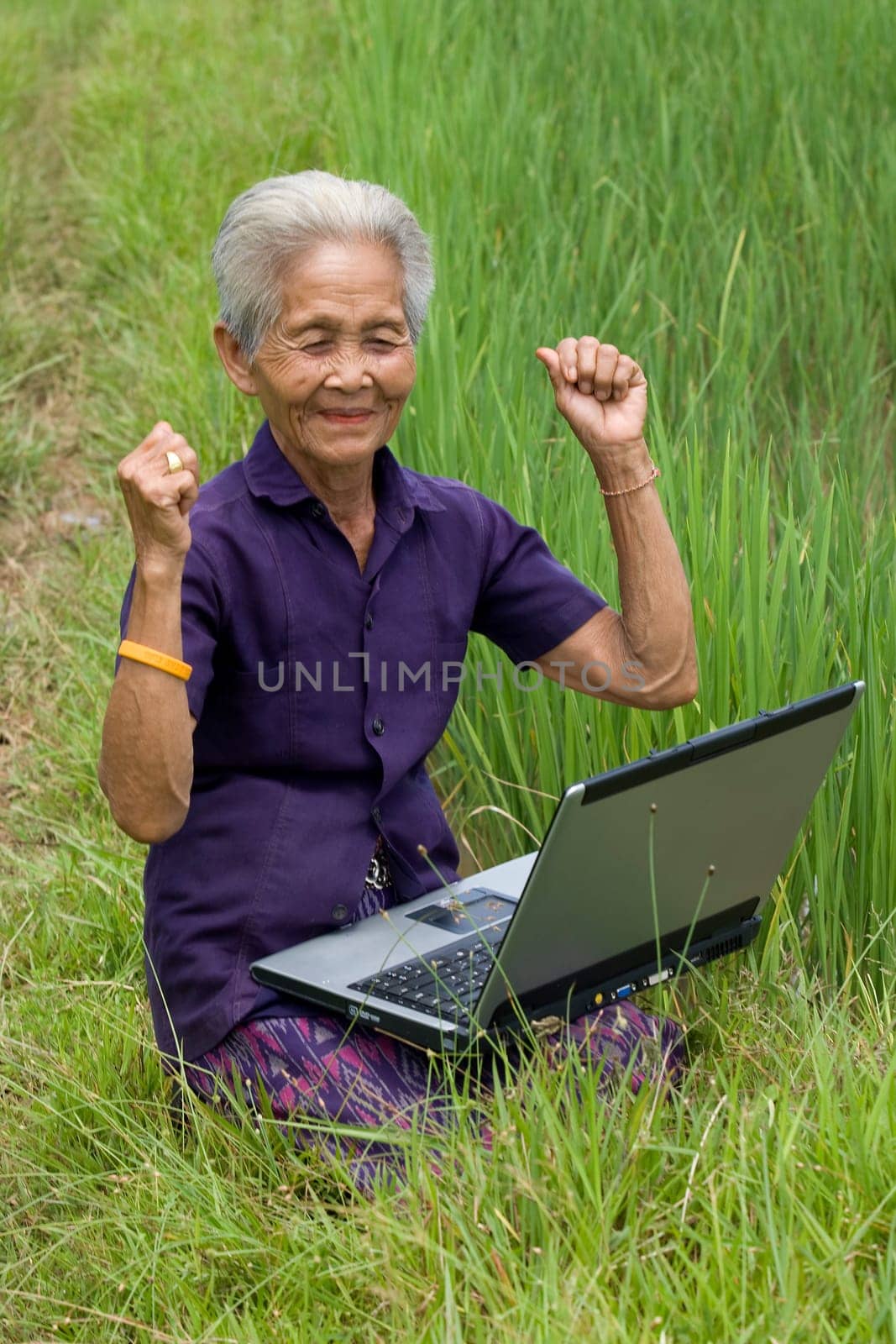Old Asian woman with laptop