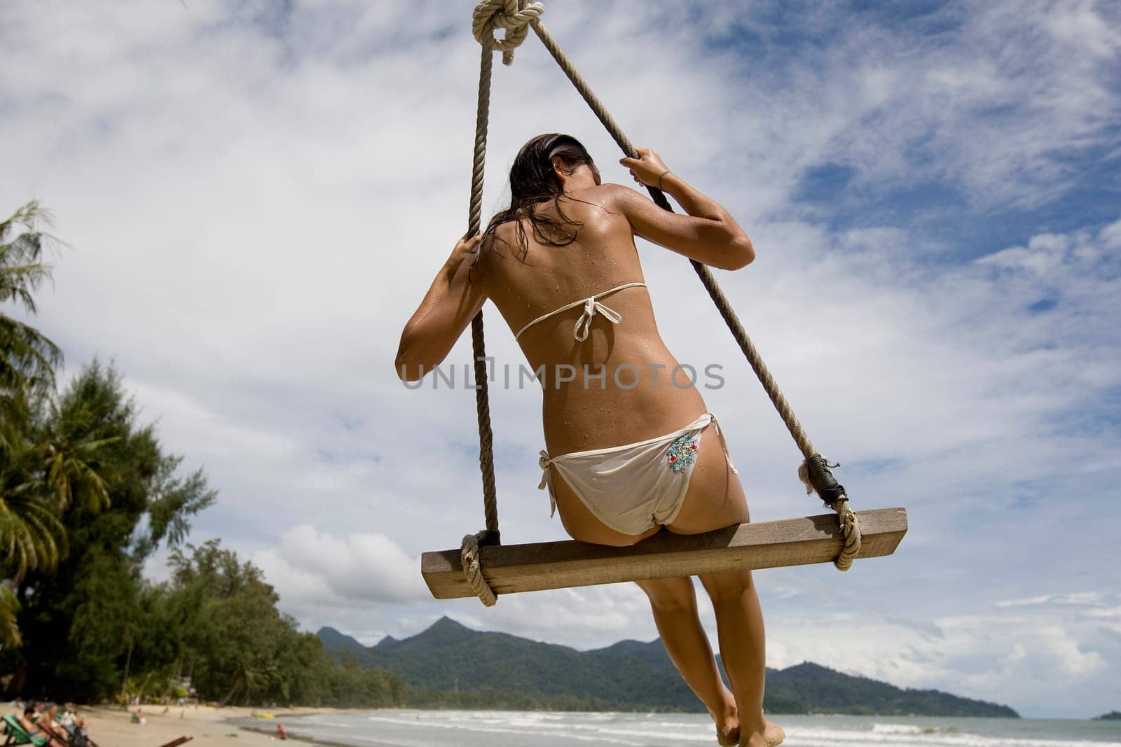 Girl on swing on the beach