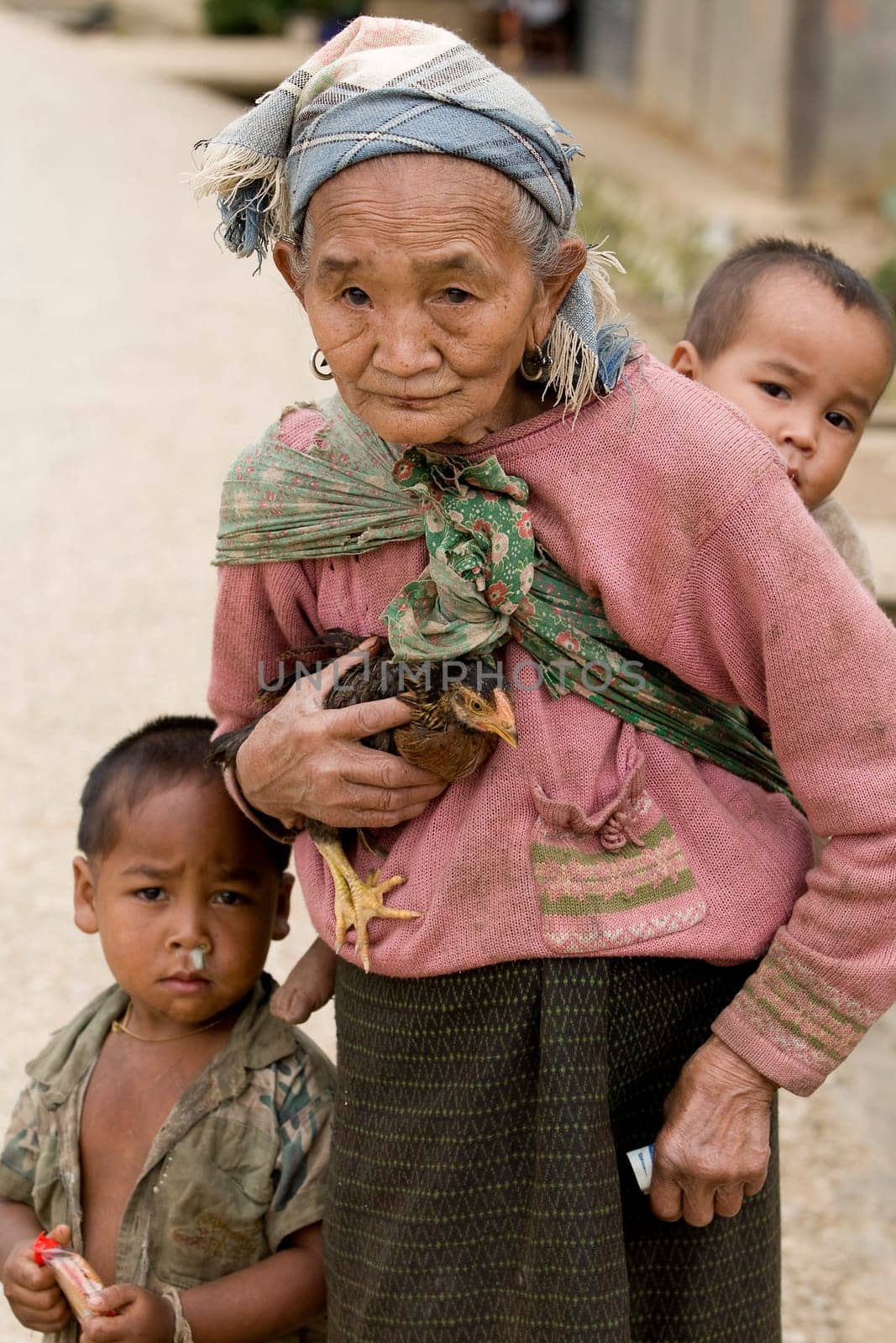 Asia,old woman with chicken and grandson