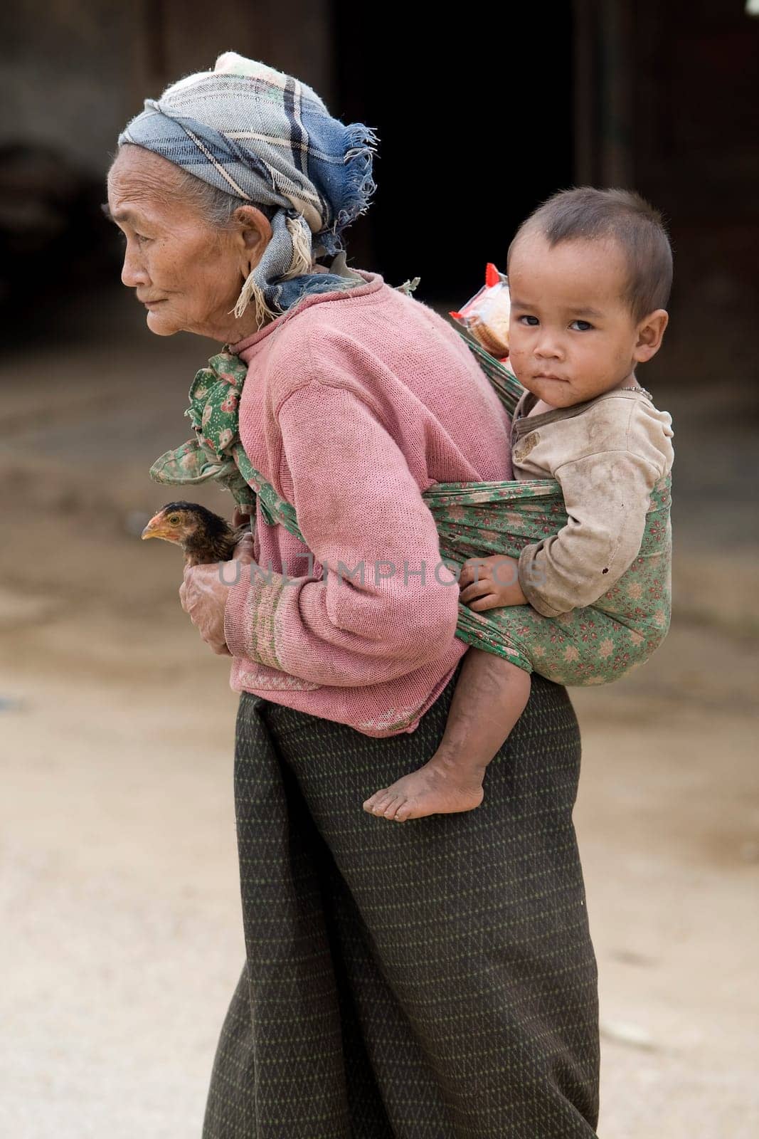 Asia,old woman with chicken and grandson