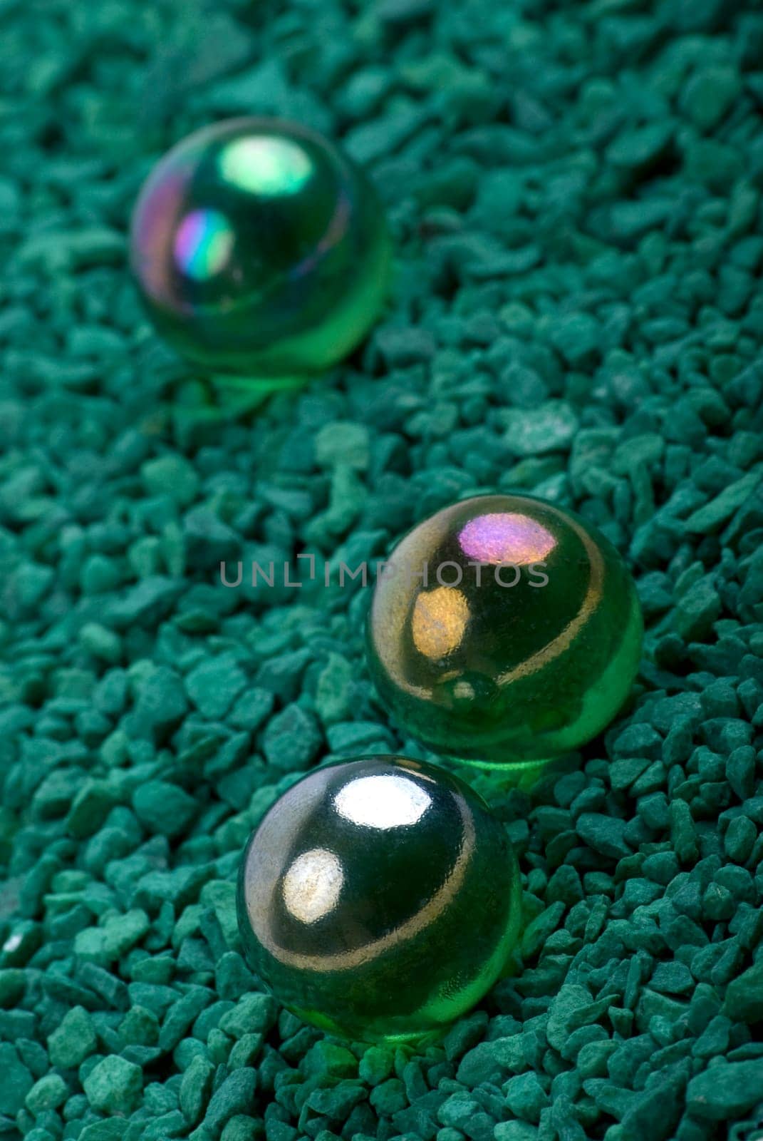 Glass marbles on green gravel