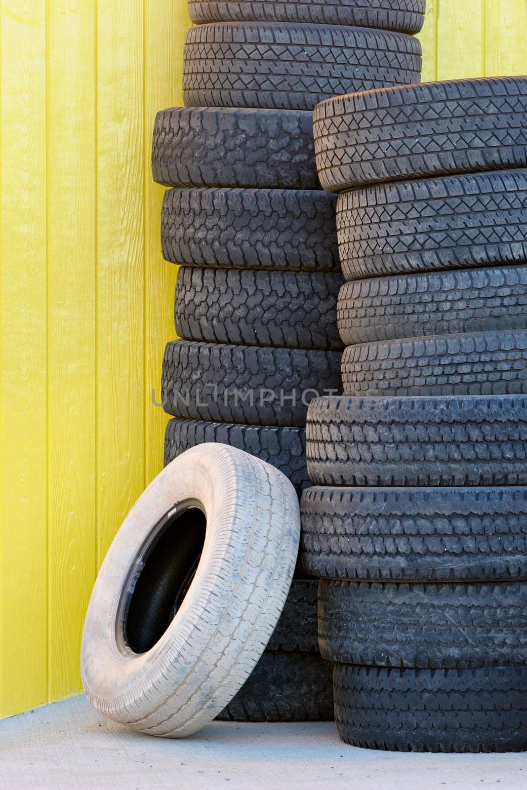 tires against yellow wall