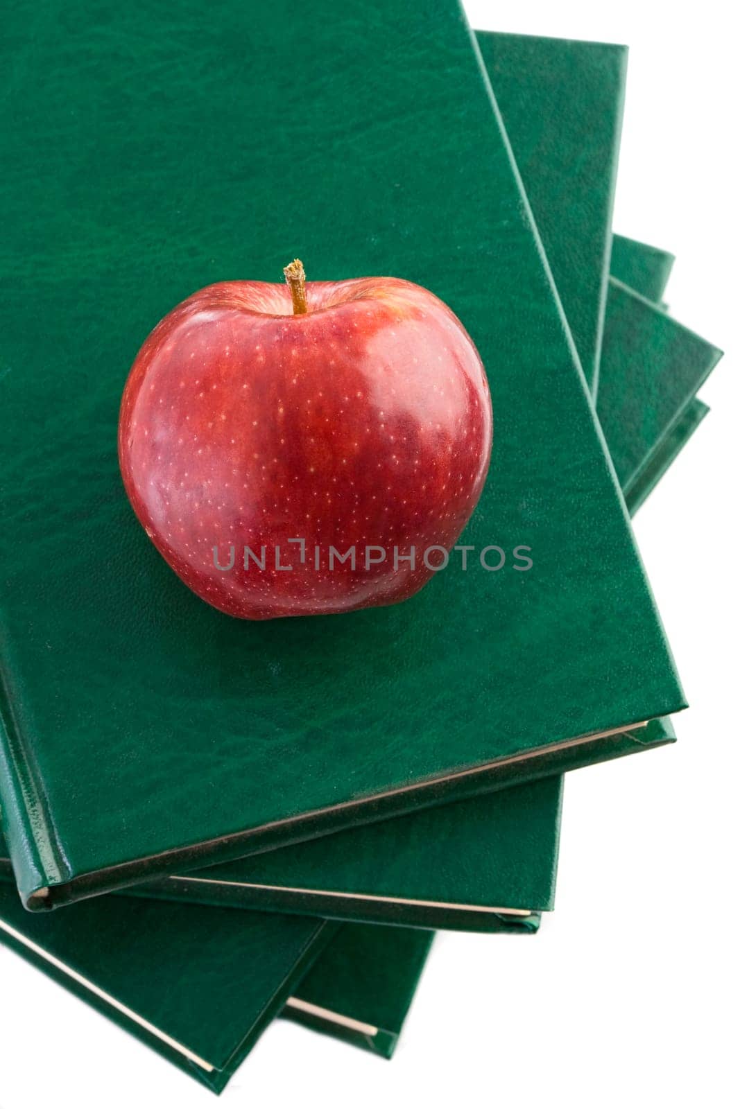 A red apple on a green book
