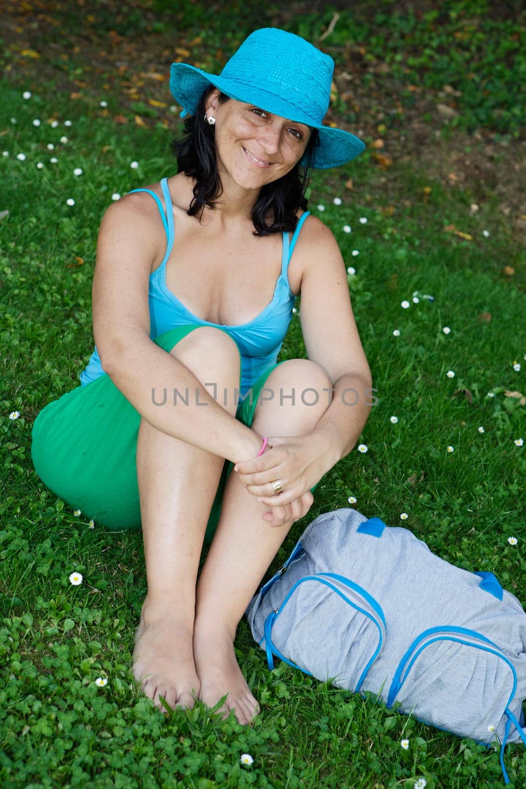 Beautiful girl sitting on grass
