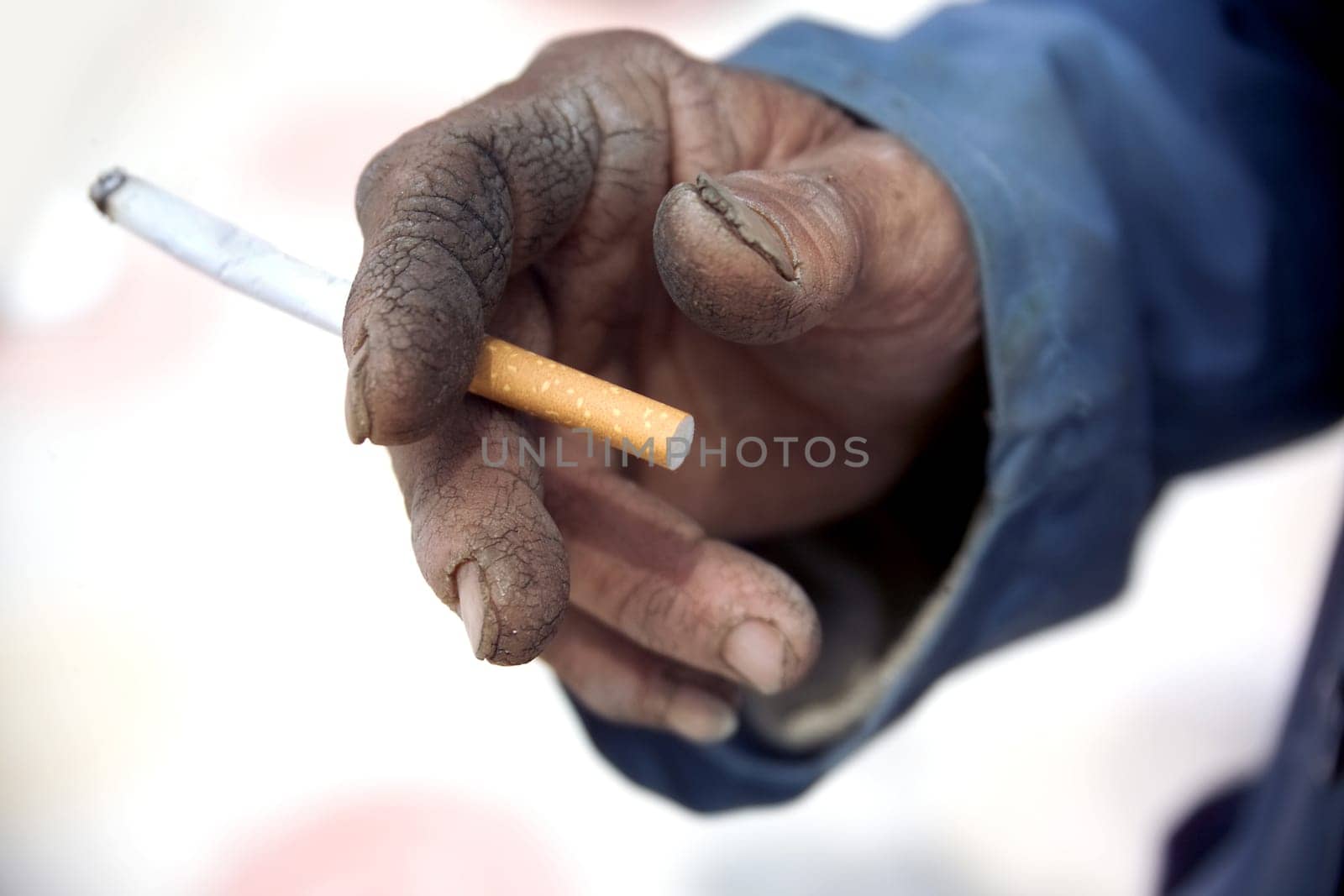 close up shot of hand holding cigarette