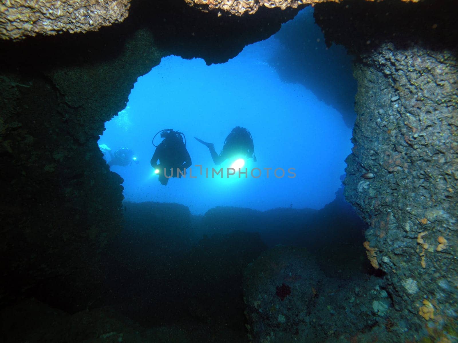 Diver in front of cave entrance