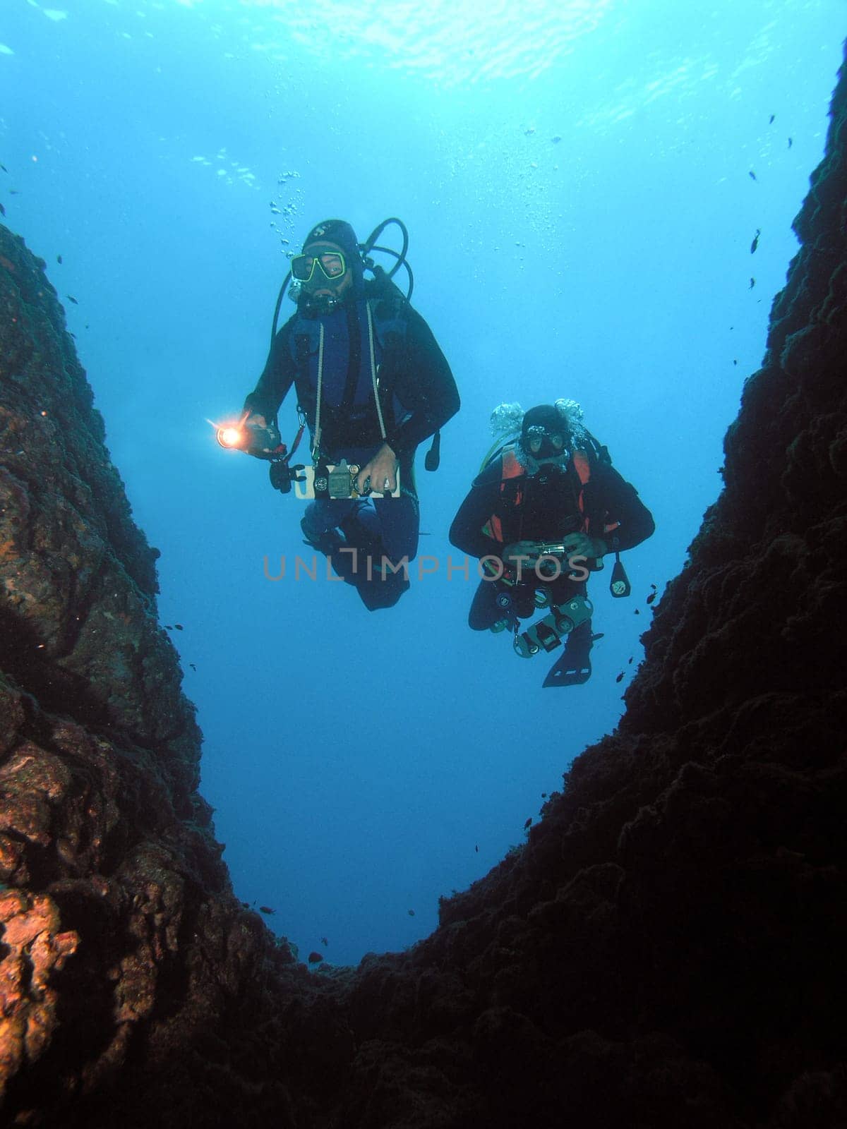 Diver in front of cave entrance