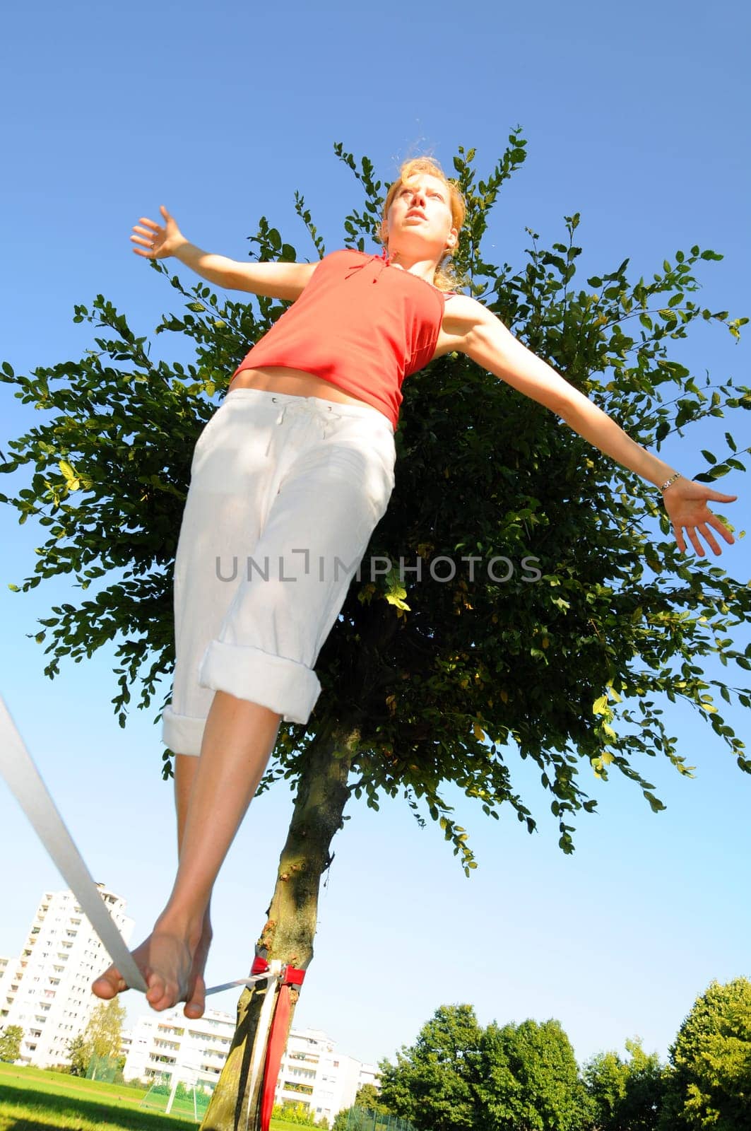 Woman walks on slackline
