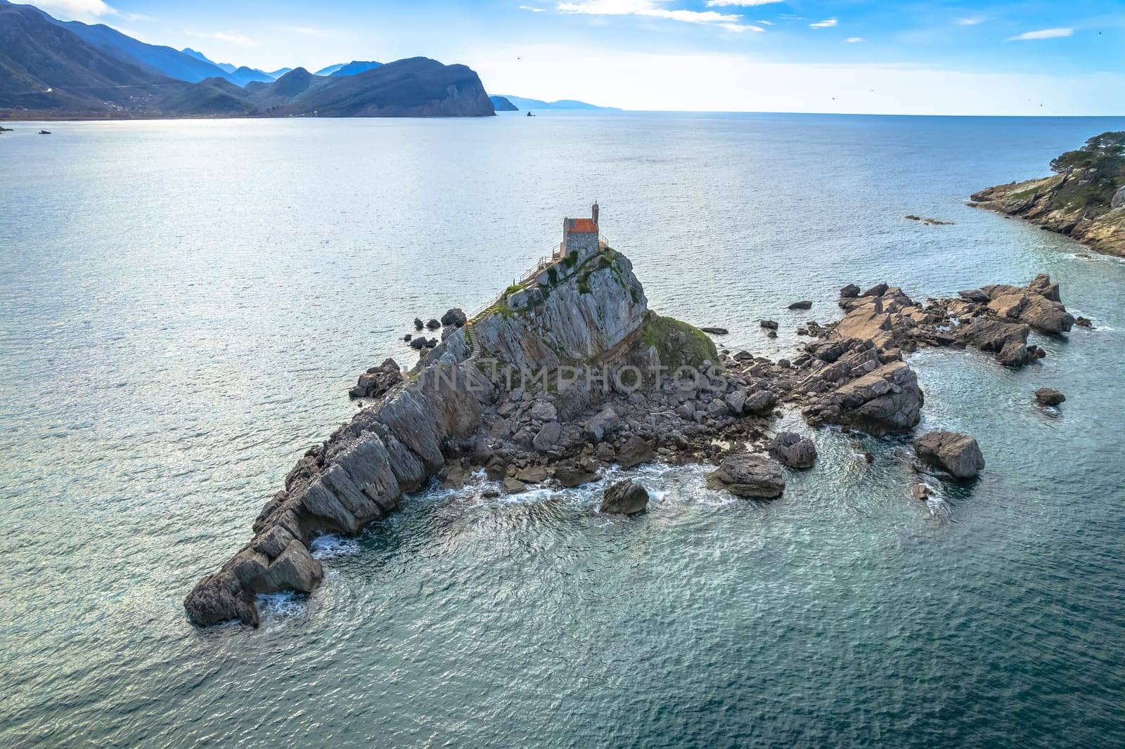 Church on the rock on Katic islet in Petrovac aerial view, archipelago of Montenegro