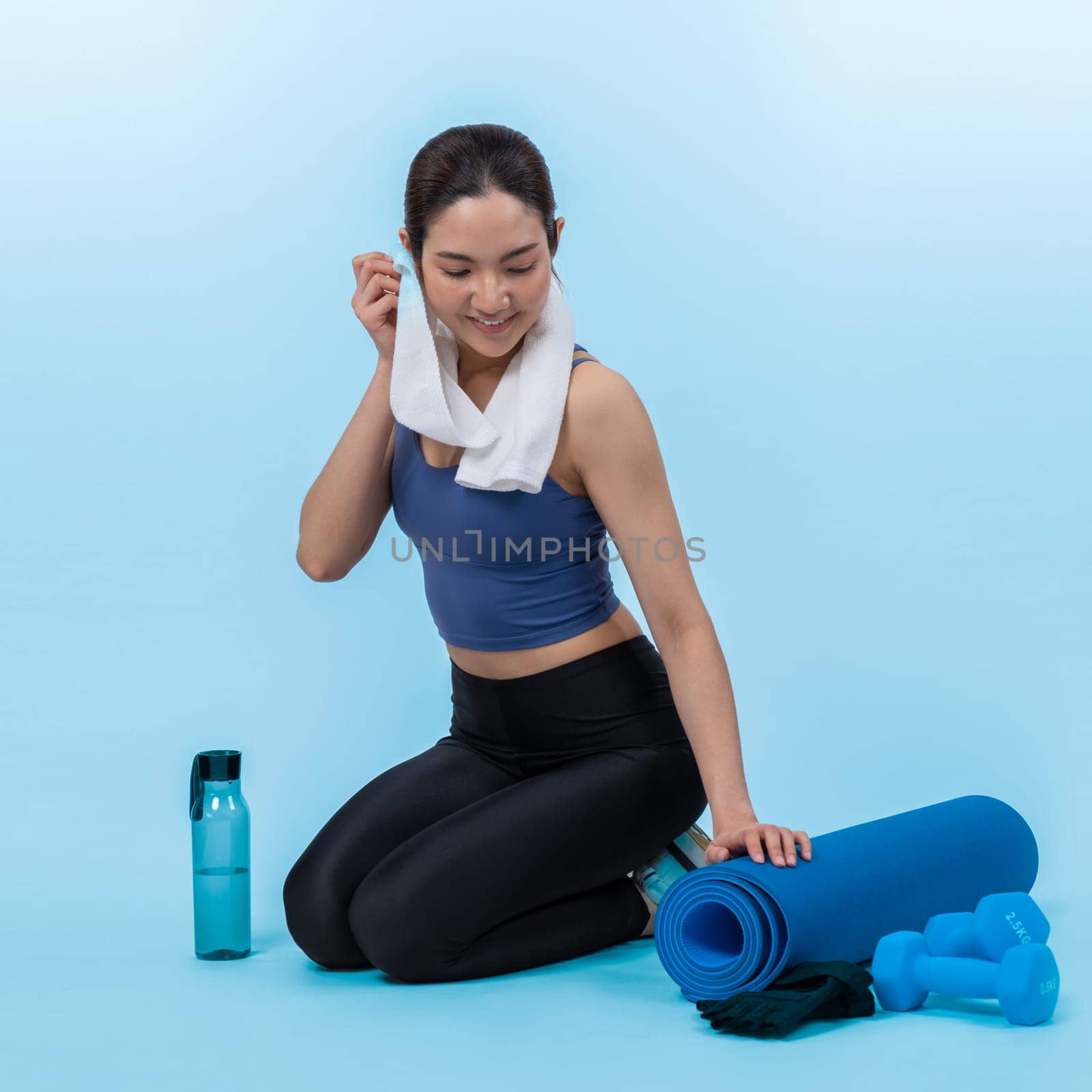 Athletic and sporty asian woman resting after intensive cardio workout training. Healthy exercising and fit body care lifestyle pursuit in studio shot isolated background. Vigorous