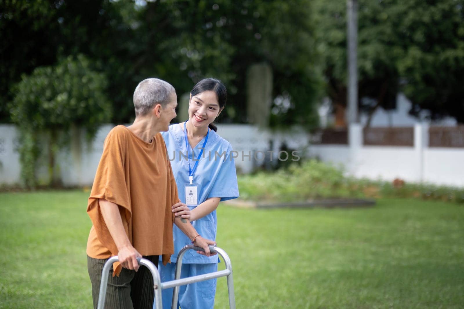 Nurse or caregiver hand on walking frame for support, help or trust moving leg in rehabilitation. Physiotherapy healthcare, Medical caregiver consulting disabled elderly patient at home.