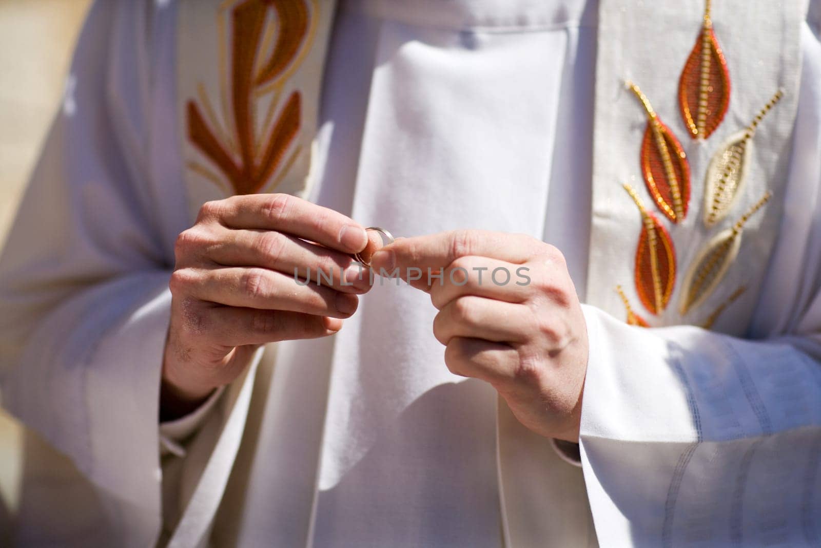 Pastor examines wedding ring