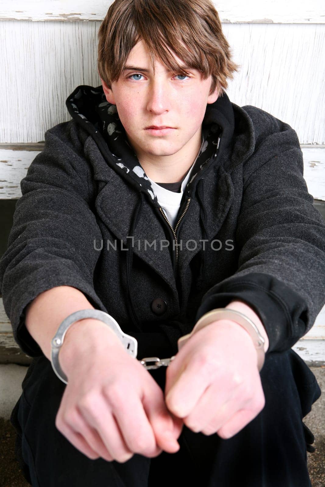 teenager in handcuffs