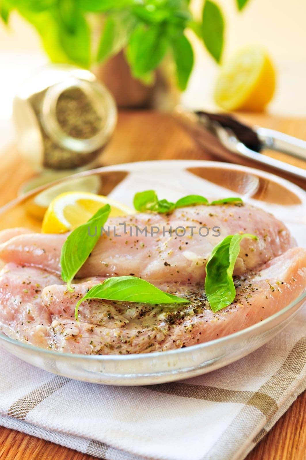 Raw chicken breasts marinating