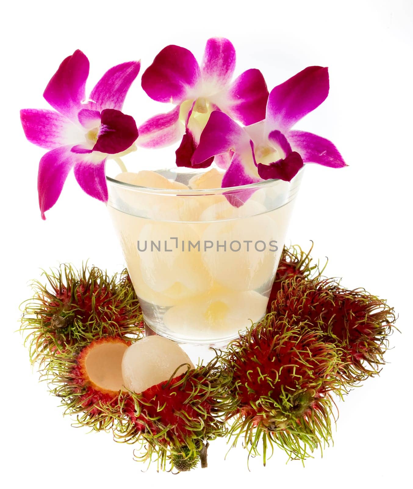 Rambutan with fruit juice and orchid
