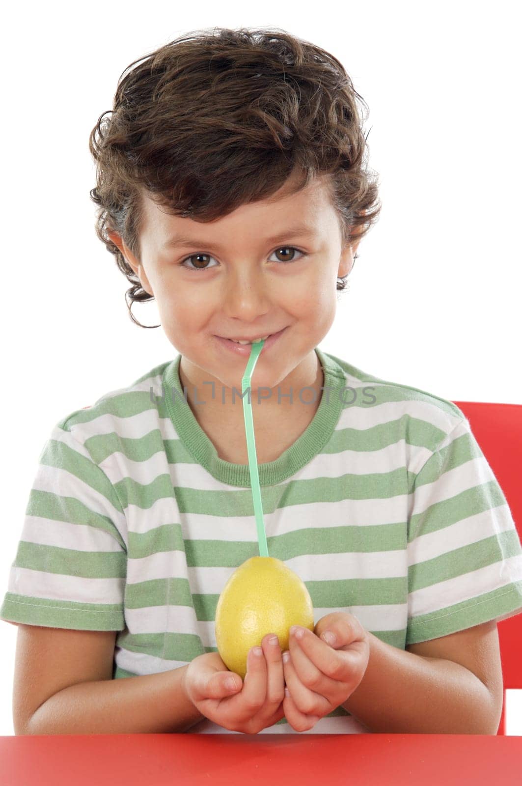 Adorable boy drinking juice of lemon