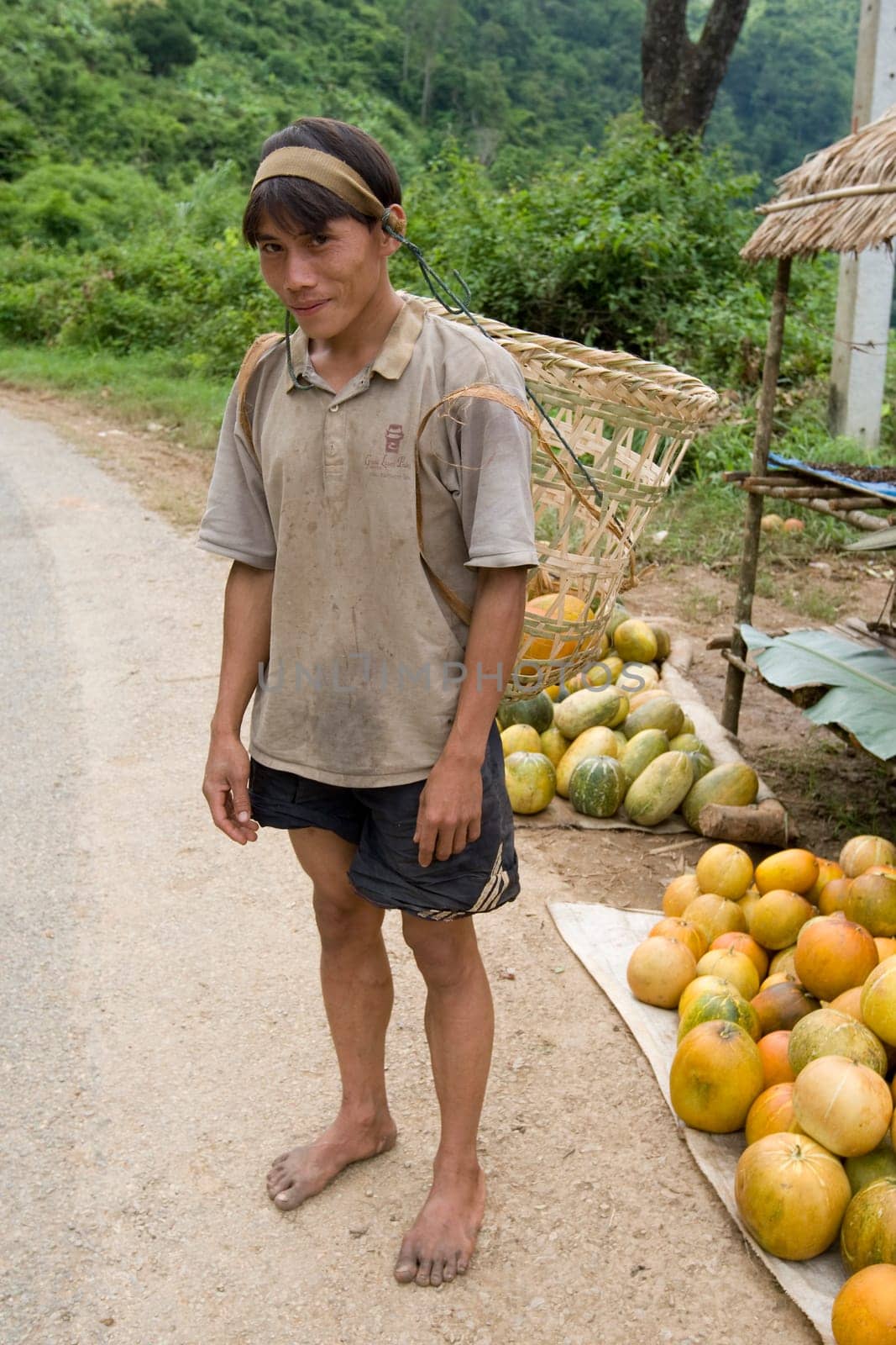 Hmong man in Laos with butte
