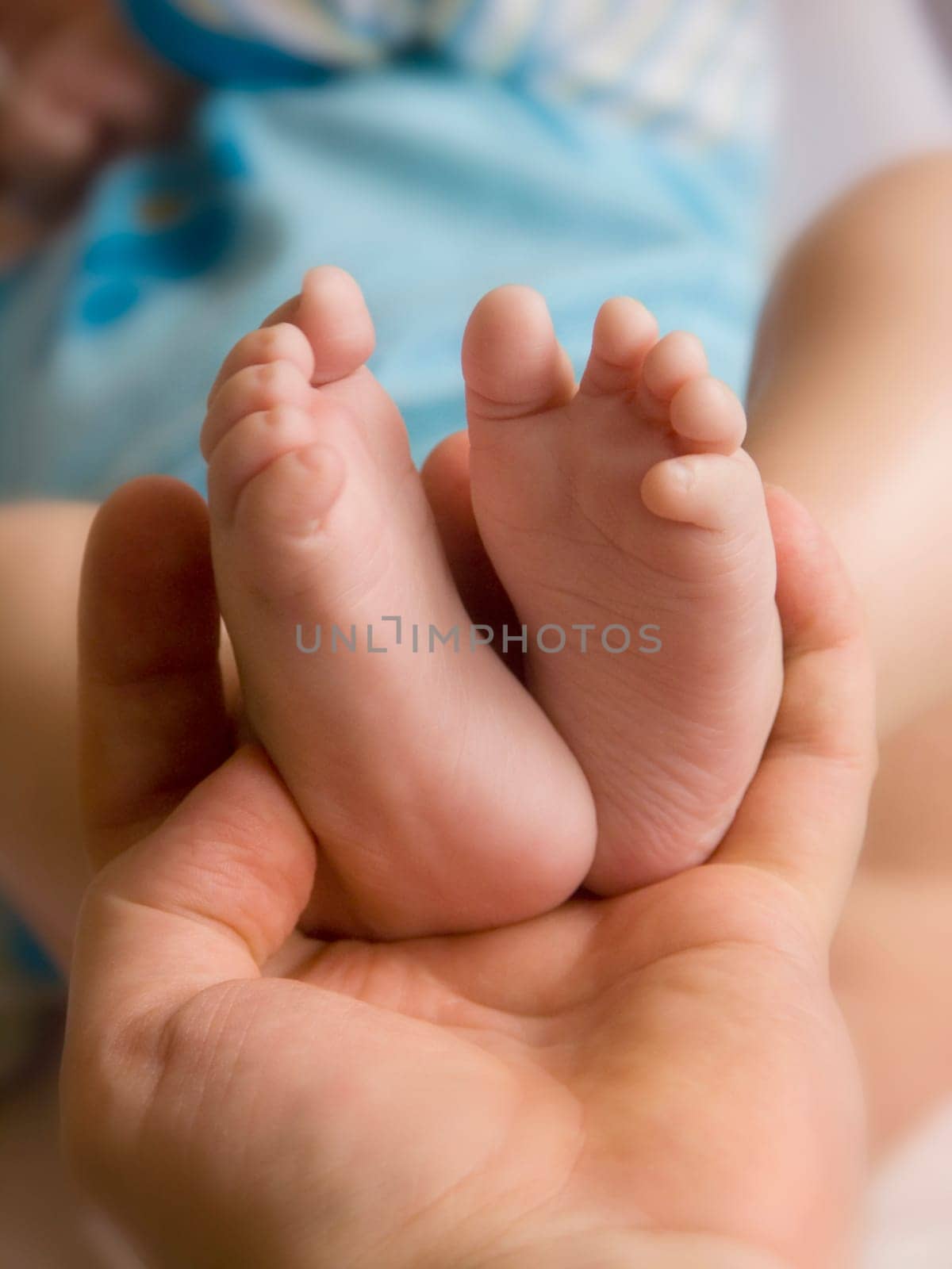 soft holding her childs little feet