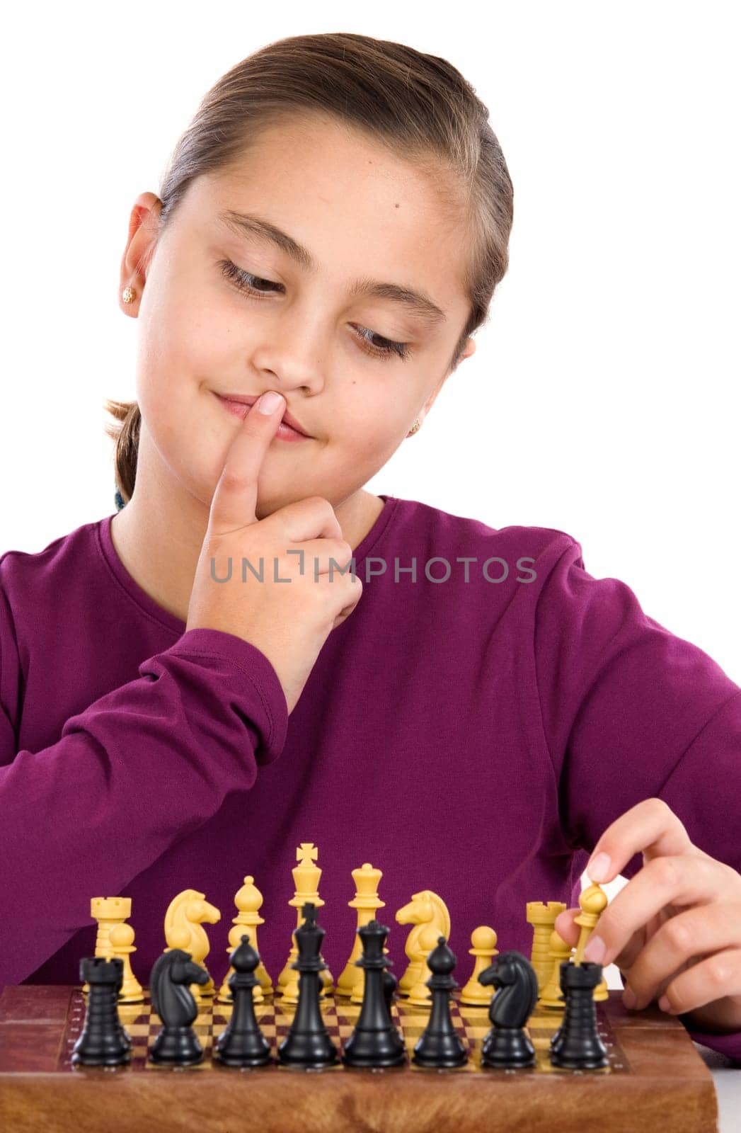 Attractive little girl playing chess