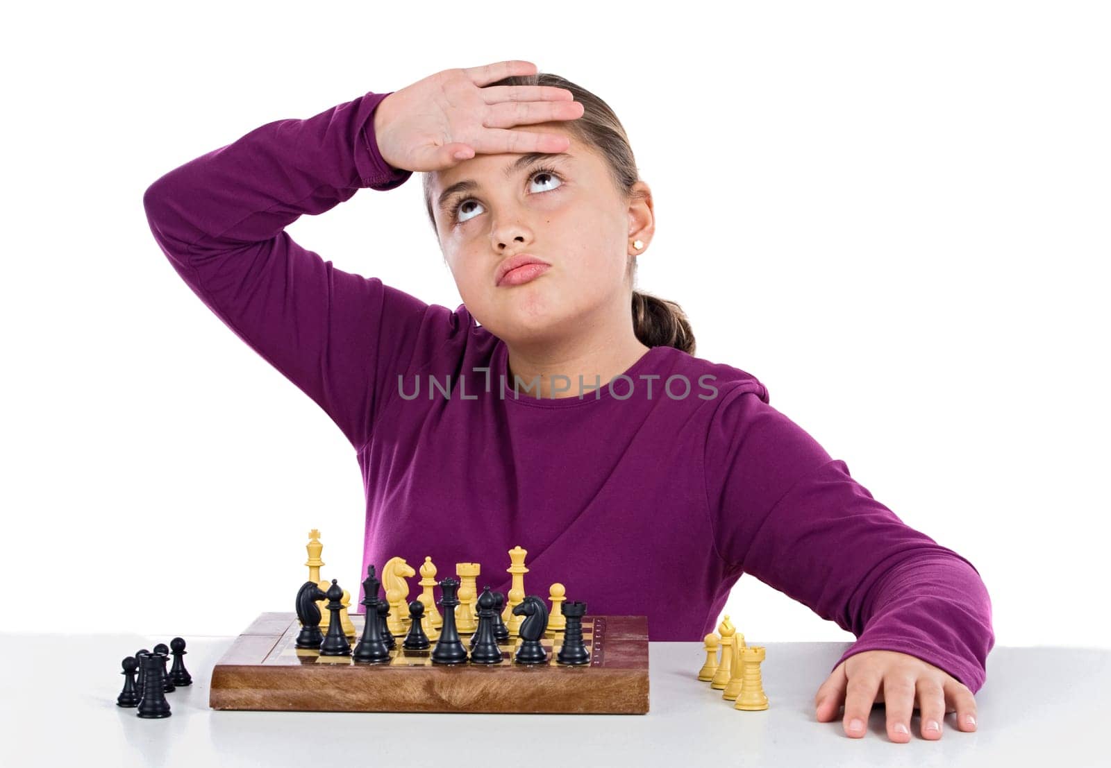 Attractive little girl playing chess