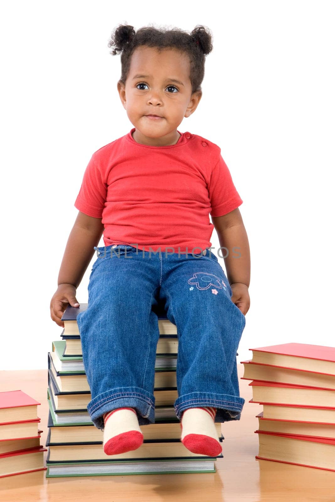 Baby sitting on a pile of books