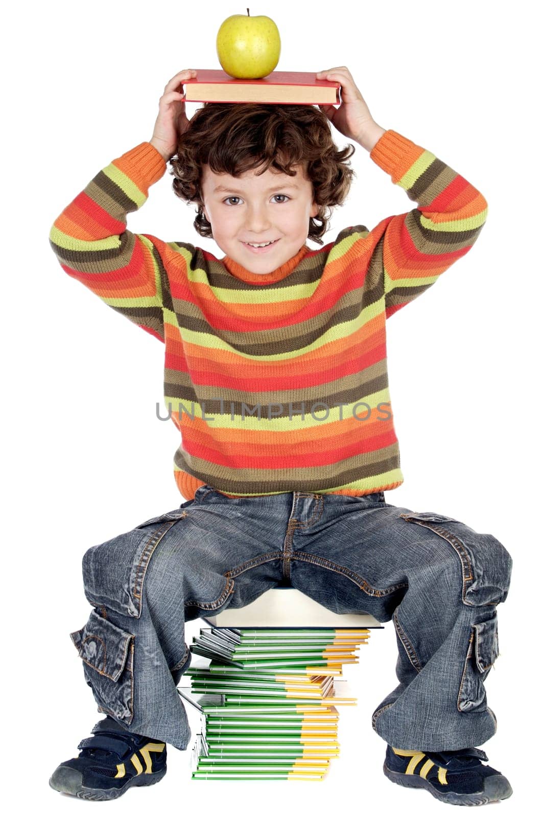Adorable child studying with books and a