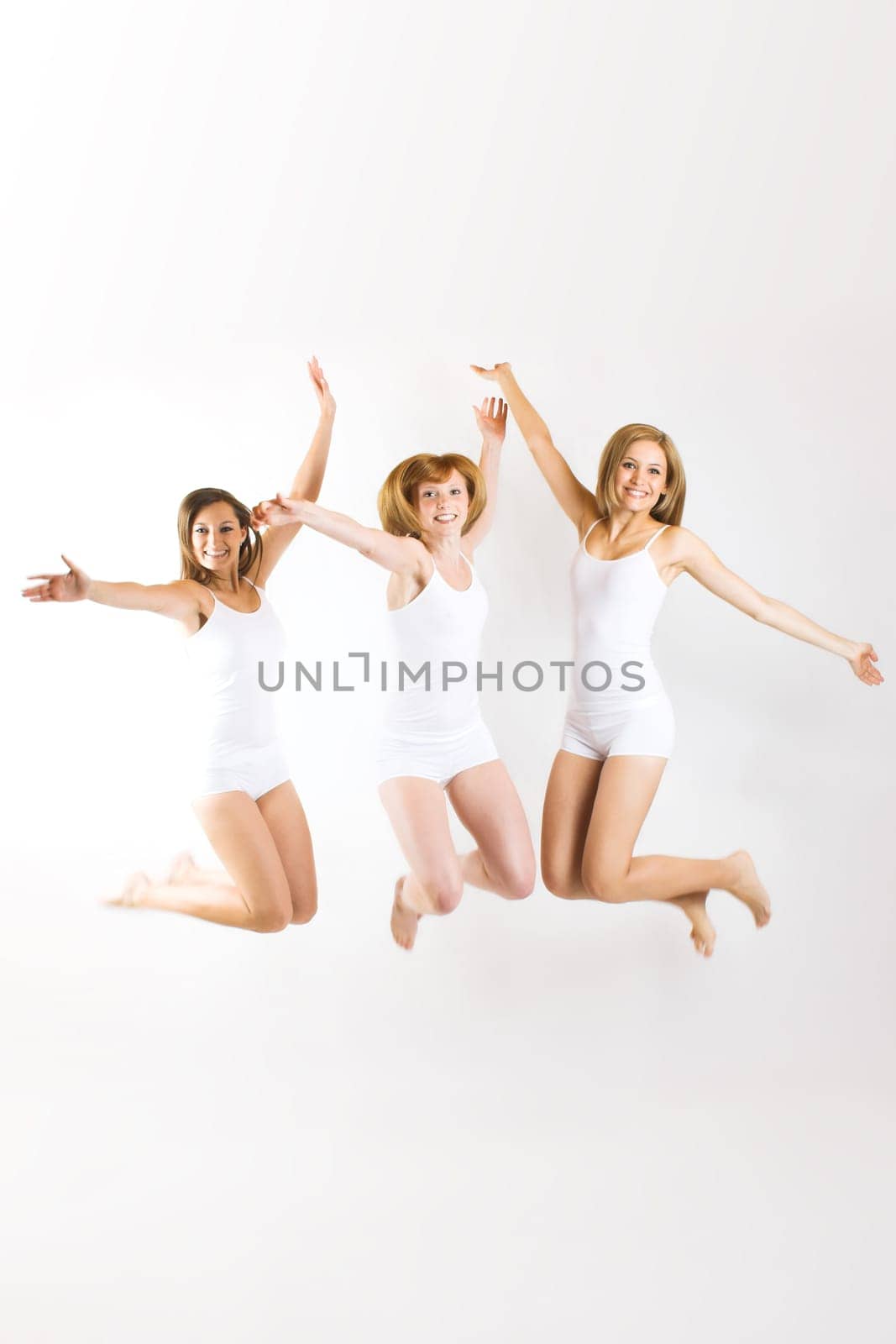 Three young women jumping