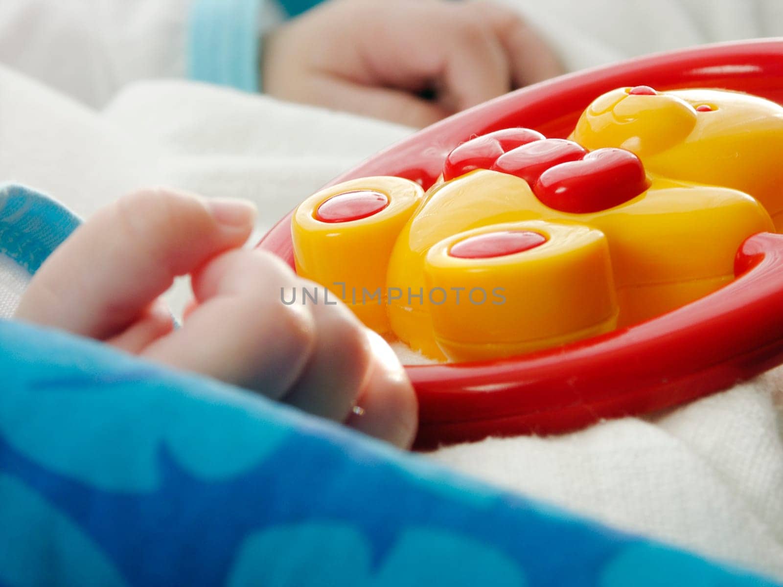 Close-up hand with baby toy - focus on toy