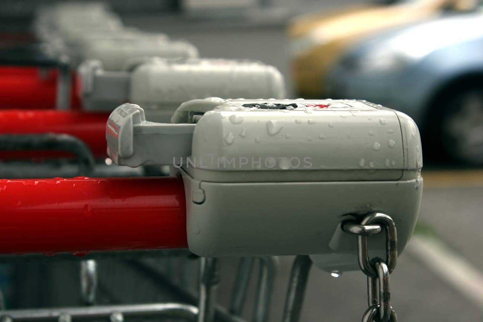 Shopping trolley with deposit compartment and chain