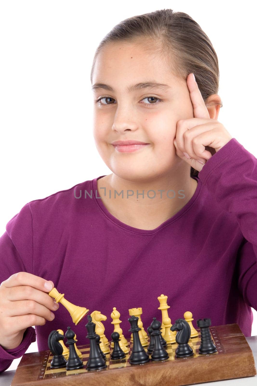 Attractive little girl playing chess