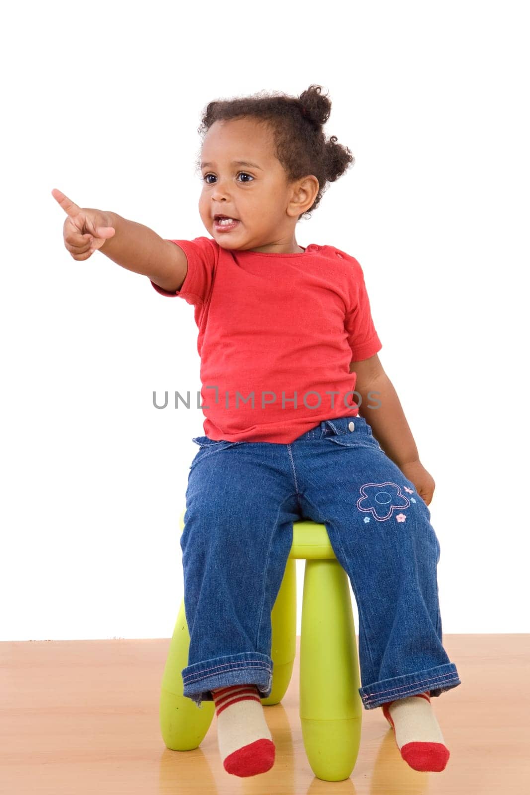 African baby sitting on a stool