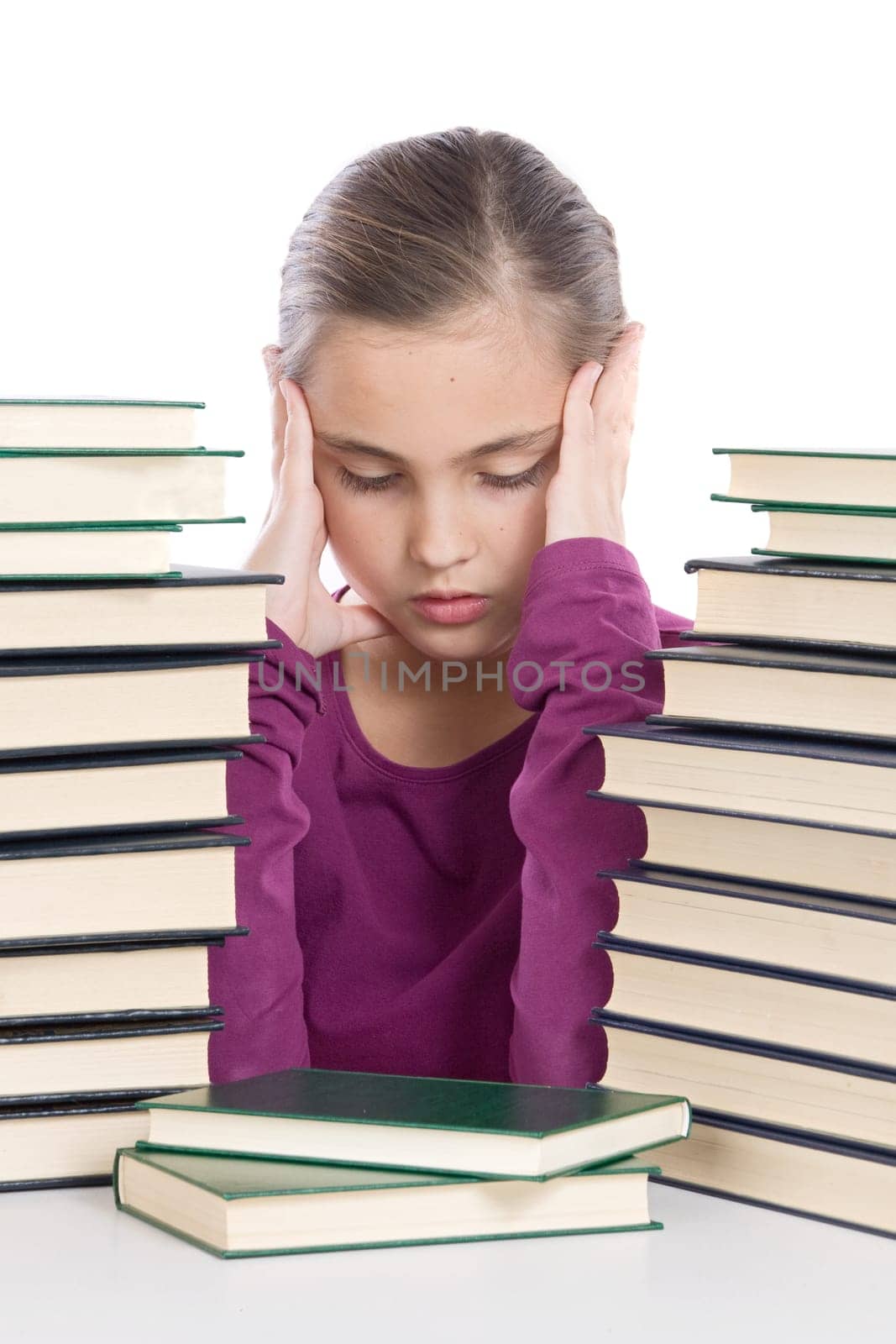 Adorable girl concentrated with books