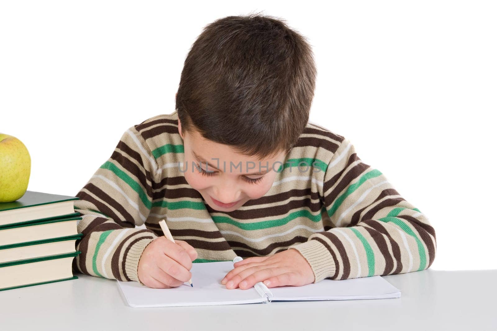 Adorable child writing in the school