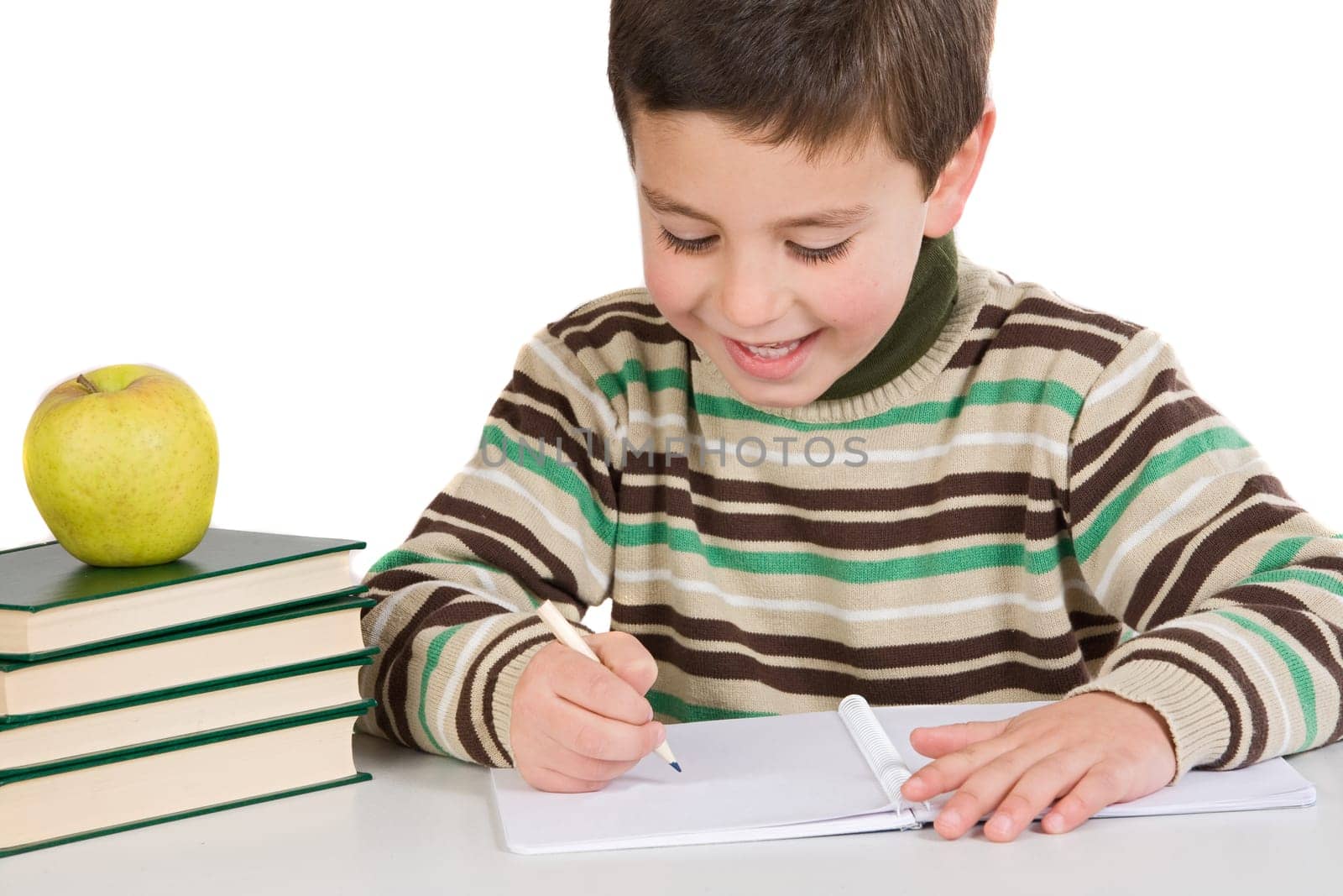 Adorable child writing in the school