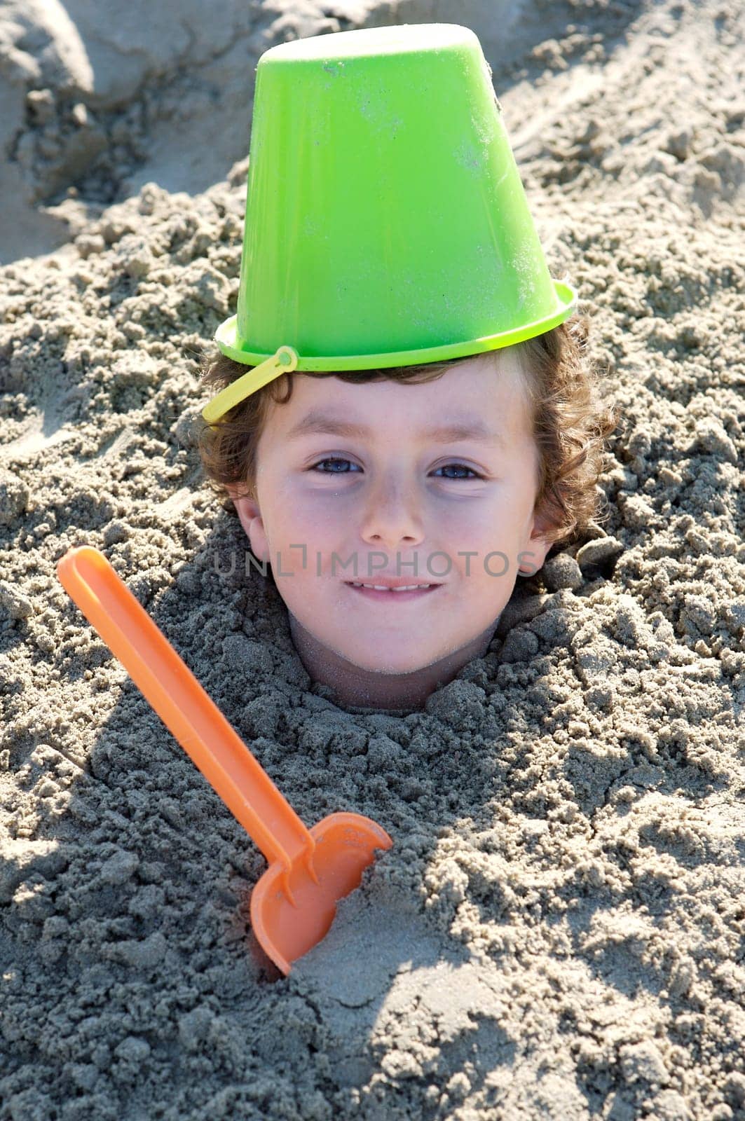 Child buried in the sand