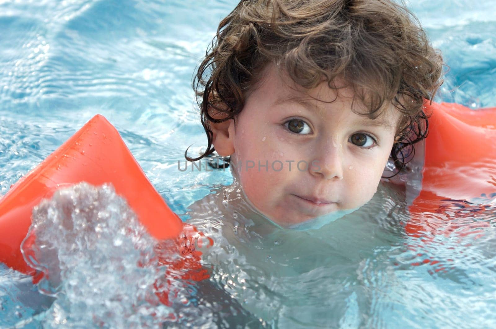 boy learning to swim