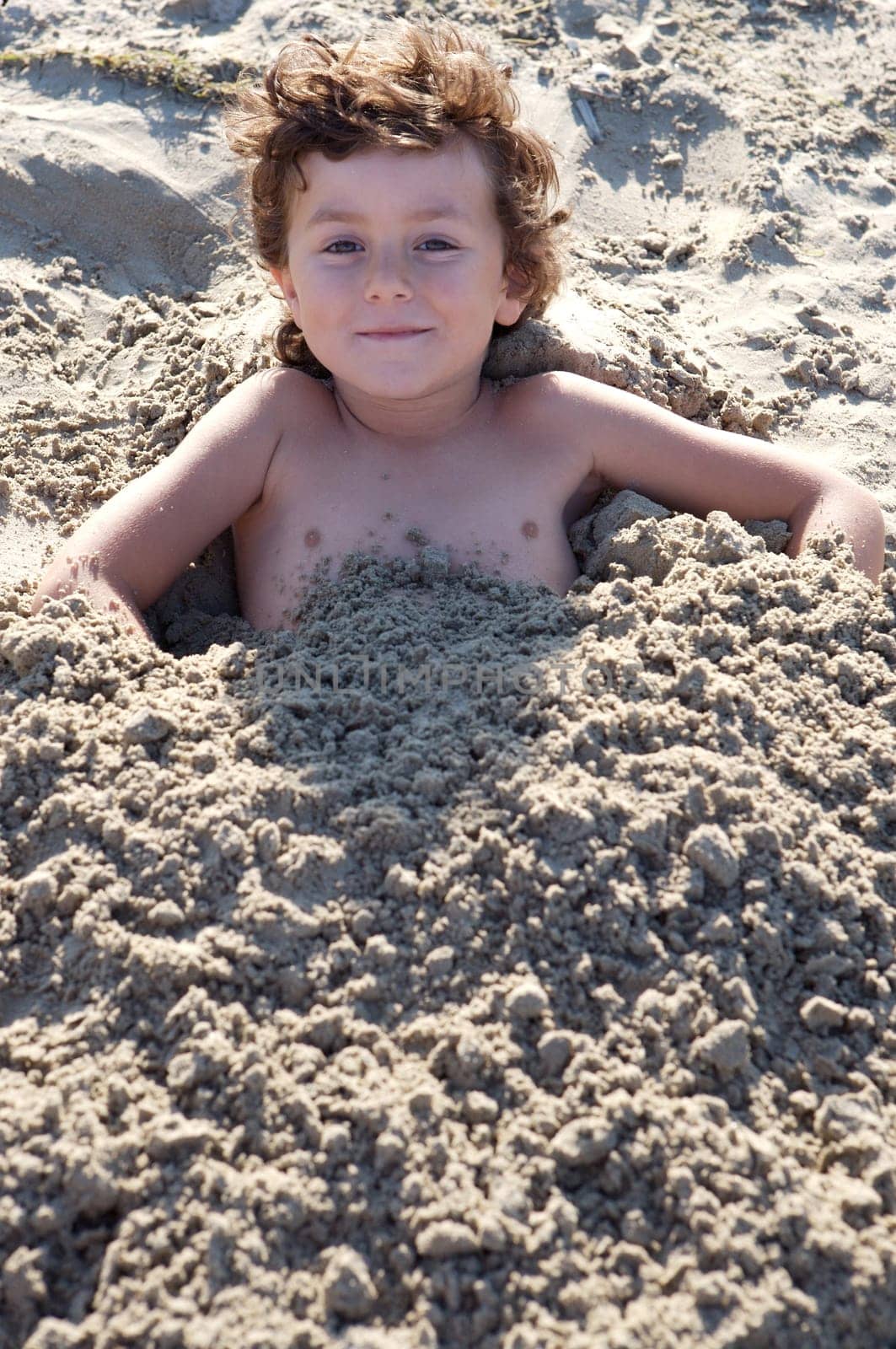 Child buried in the sand