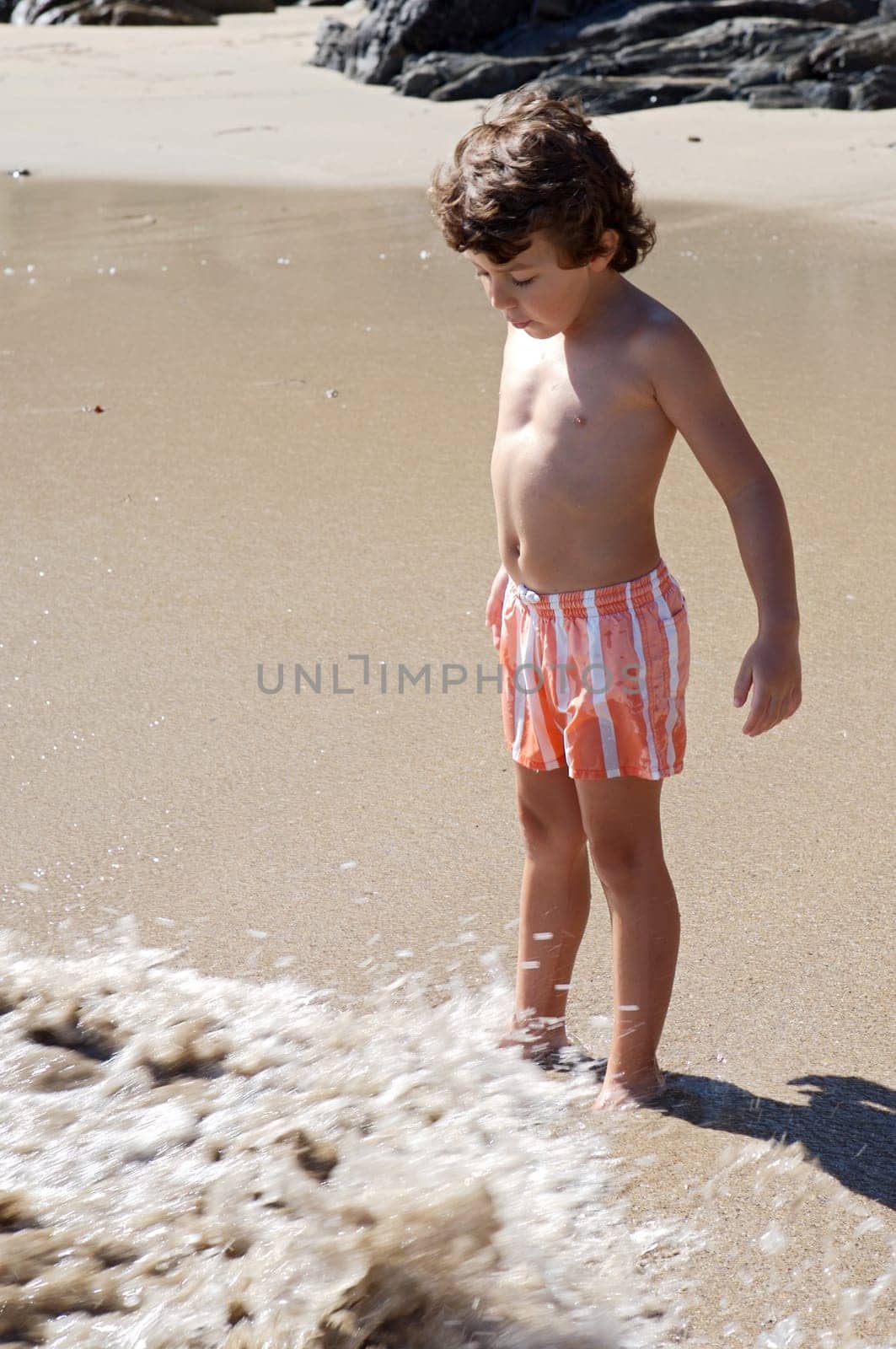 boy playing in the beach
