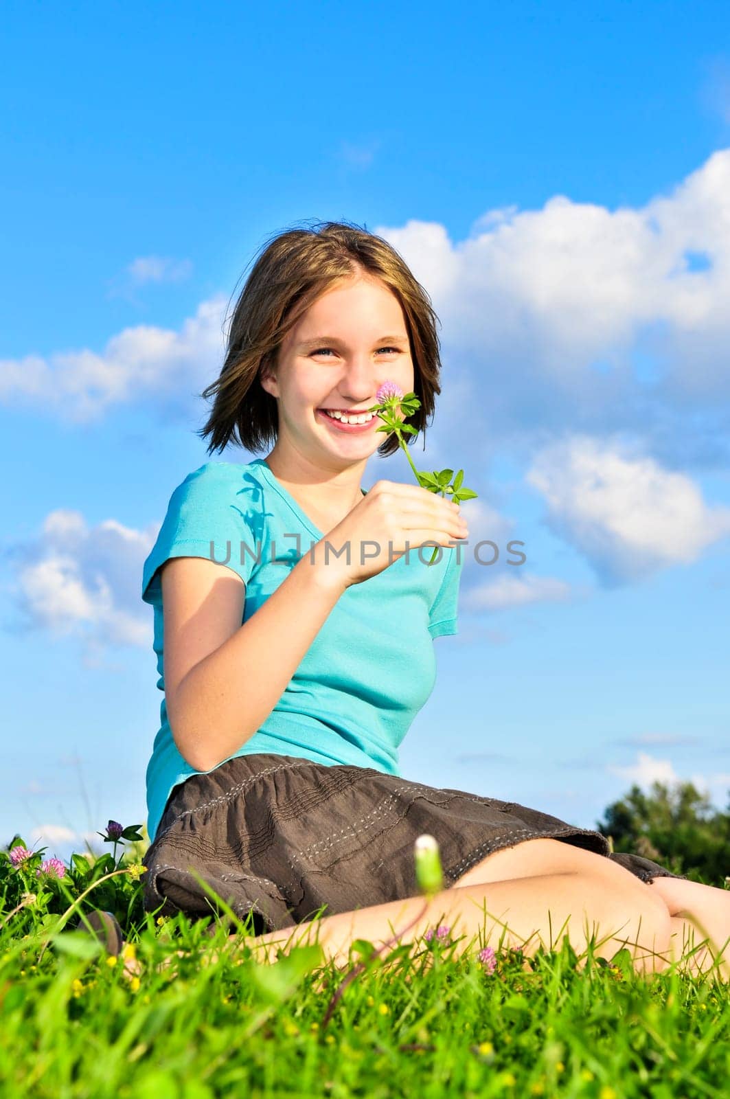 Young girl sitting on grass