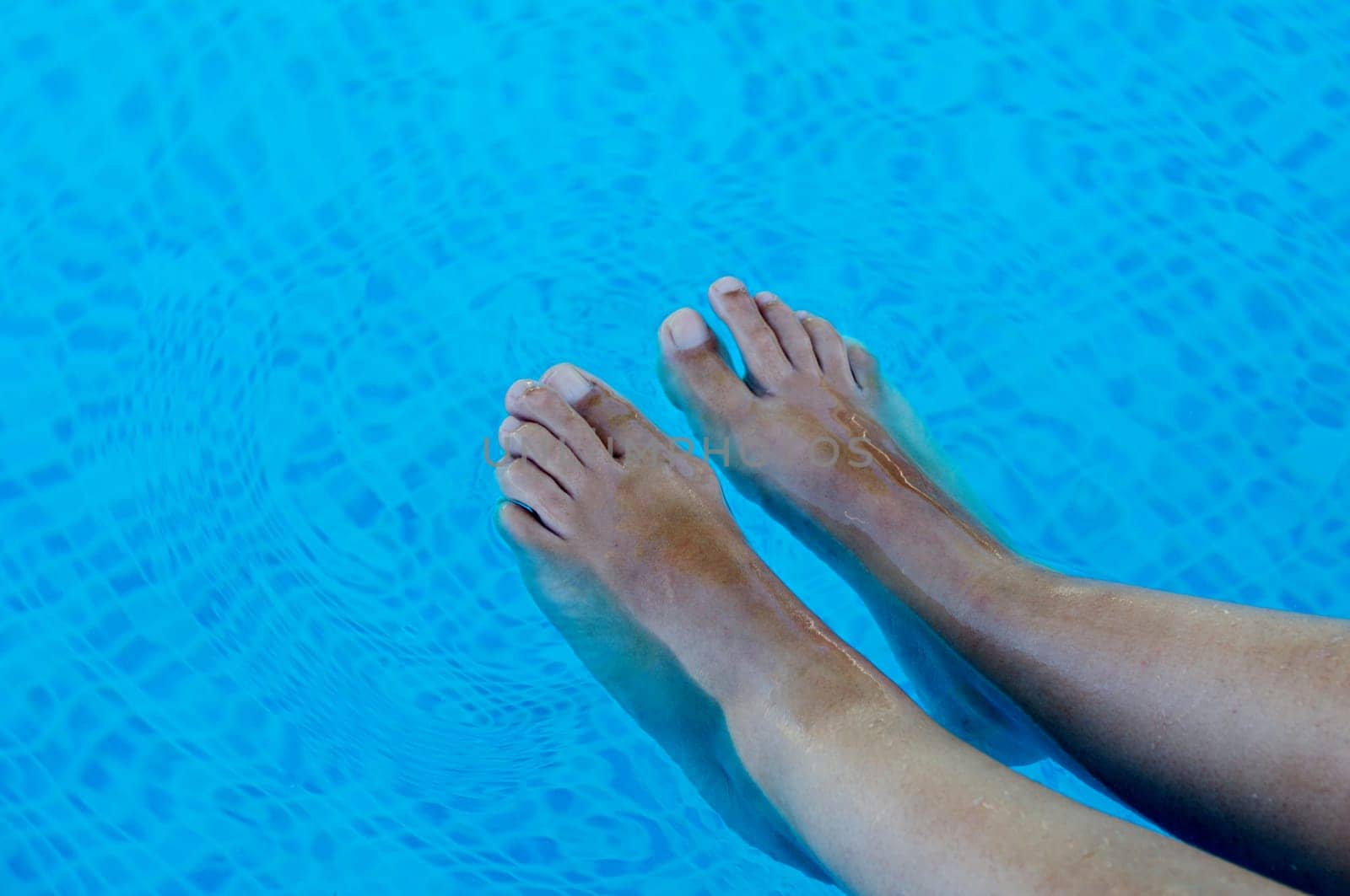 feet refreshing in swimming pool
