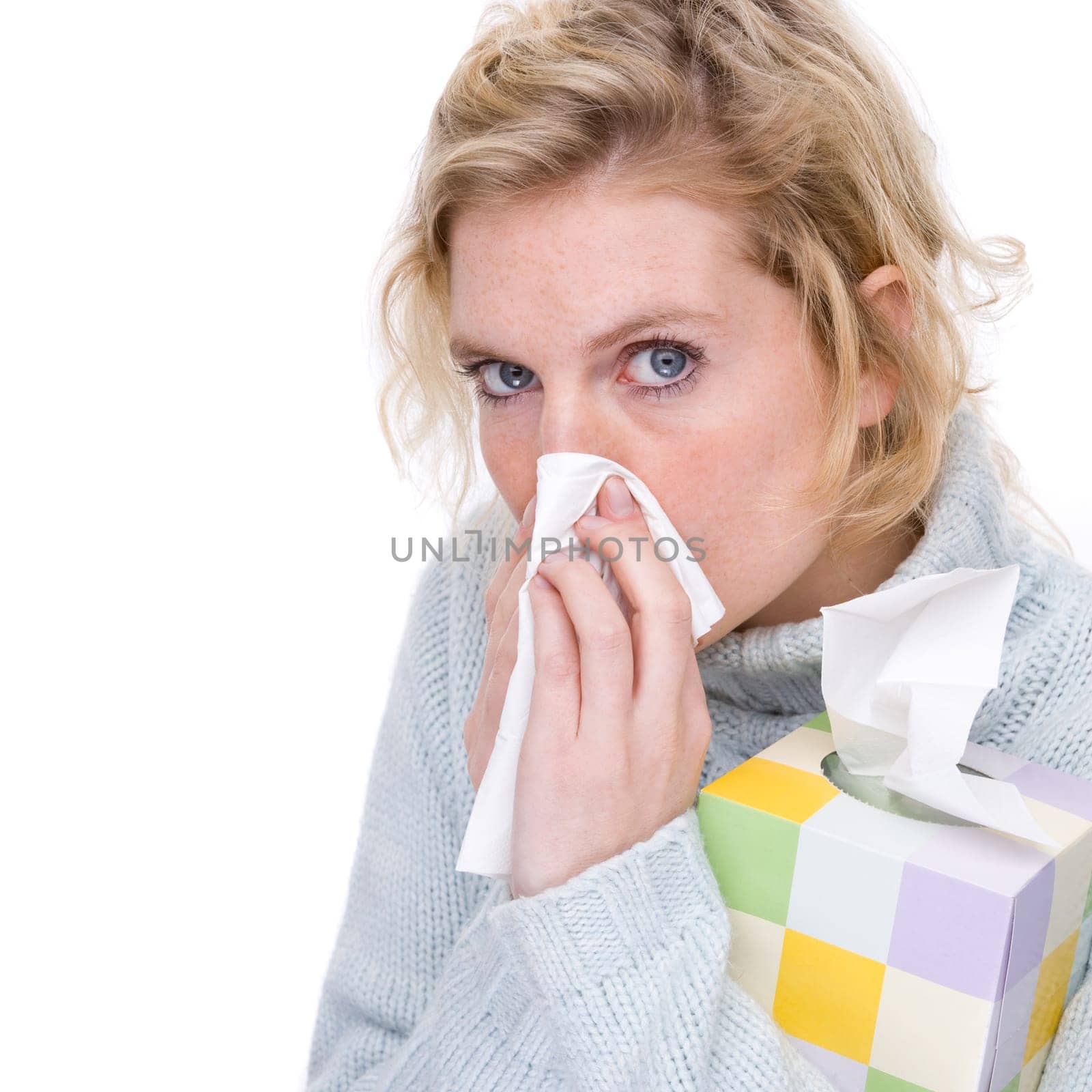 Woman blowing her nose