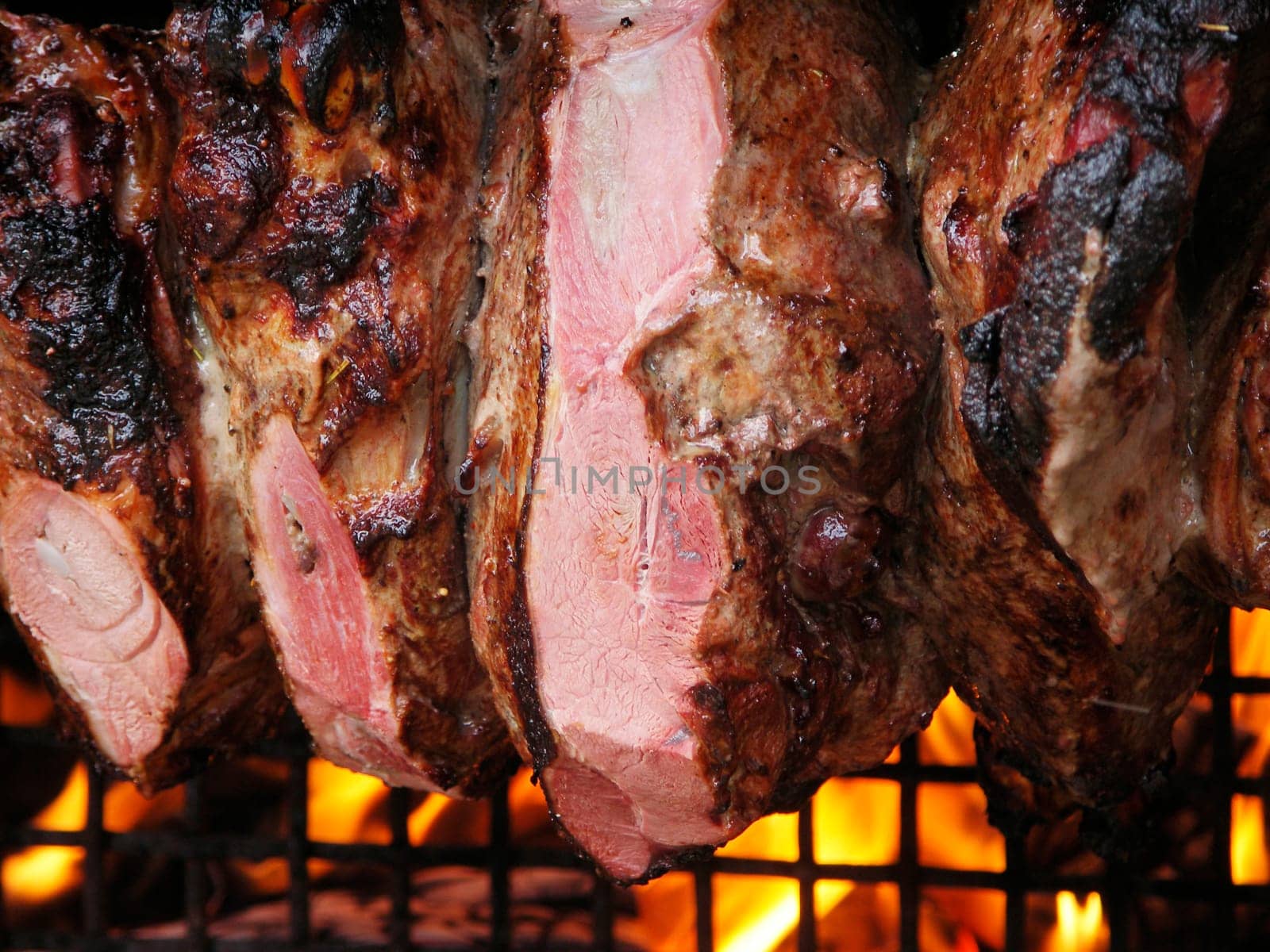 roast meat by fire with flames, traditionally eaten at different family feast